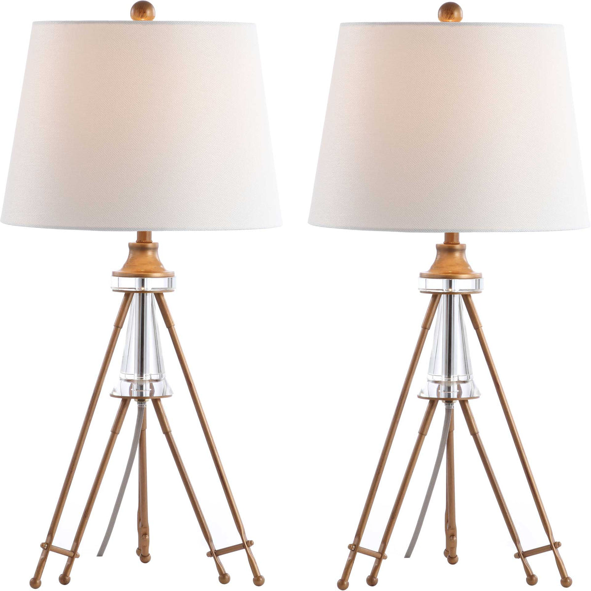A pair of gold-tone tripod lamps shines softly through textured off-white shades above clear crystal accents.