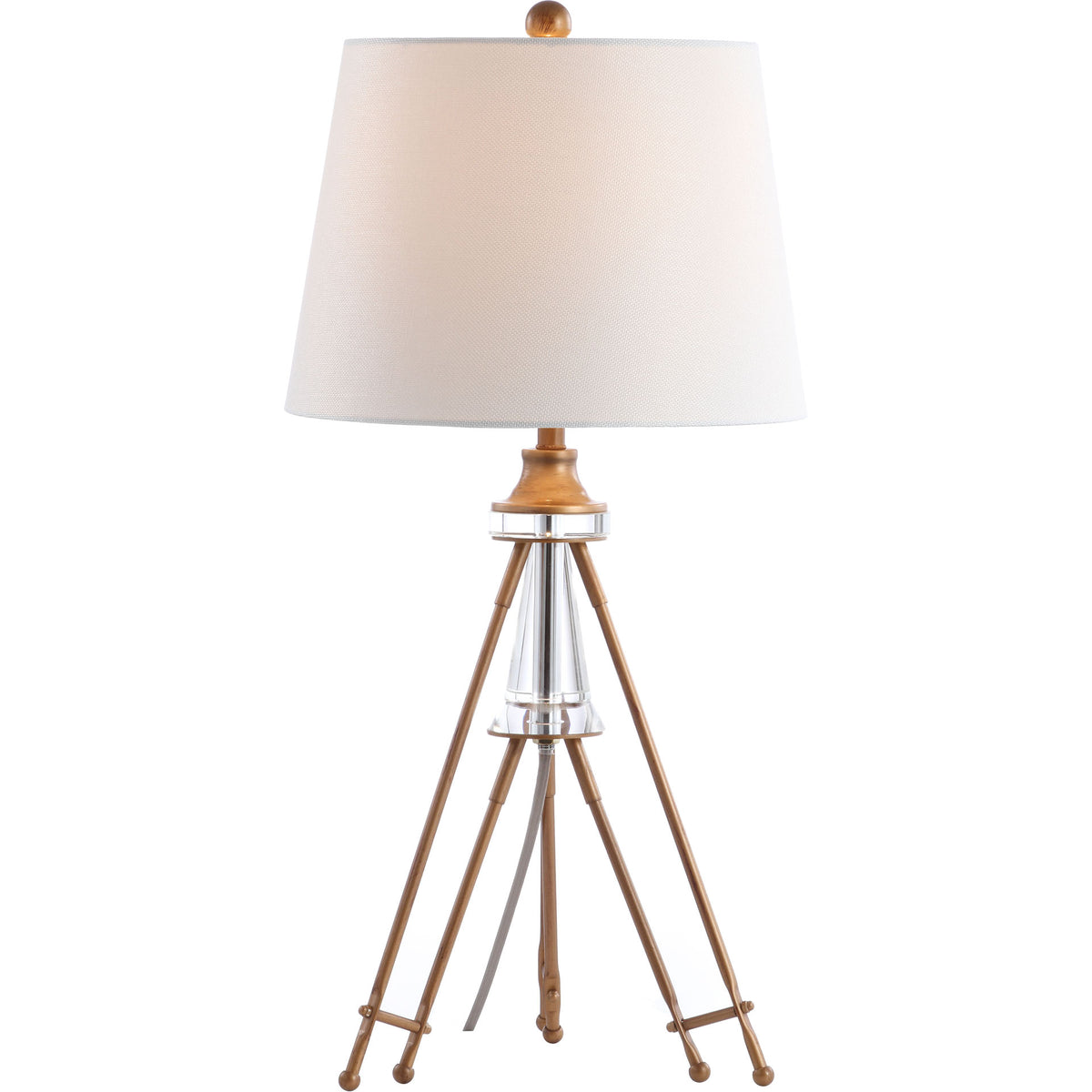 Warm light glows through an off-white shade above a crystal accent and slender gold-tone tripod legs.