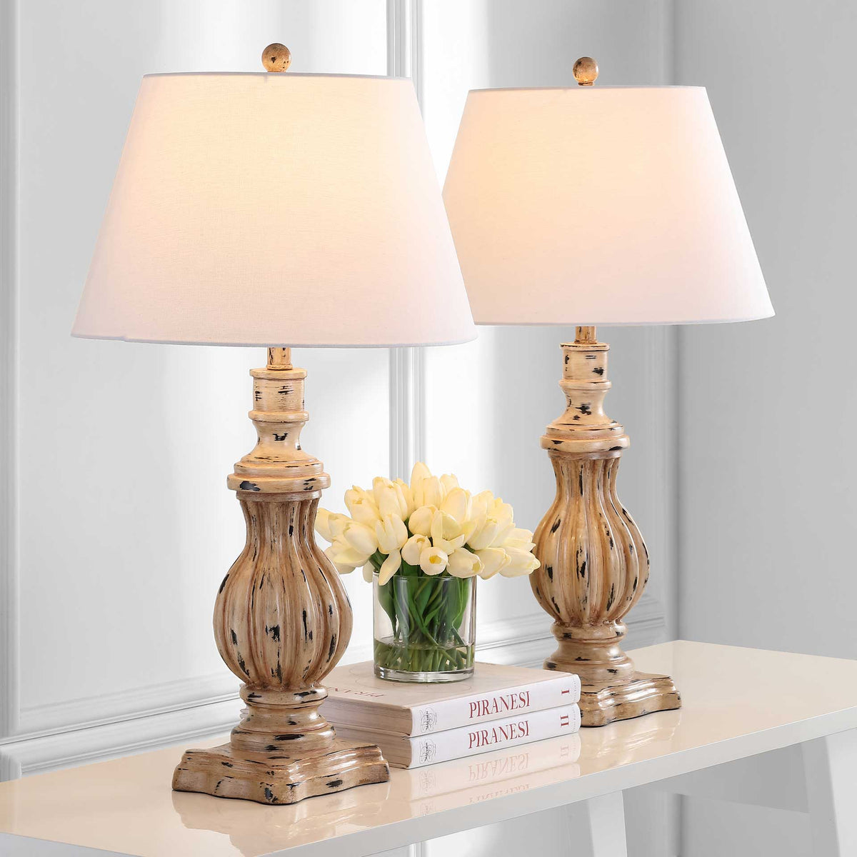 A pair of fluted brown table lamps brings a warm glow to a console.