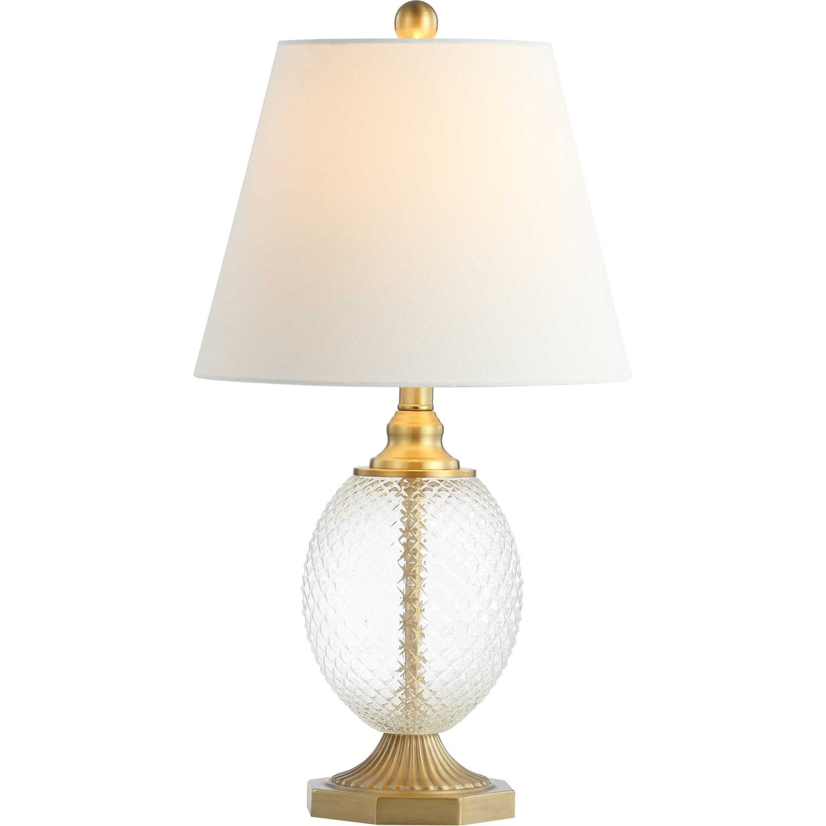 Warm light glows through the white shade above textured glass and gold-tone accents.