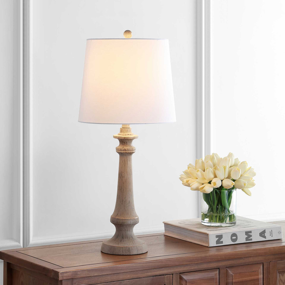 Weathered wood-look lamp with a glowing white shade brings cozy light to a console