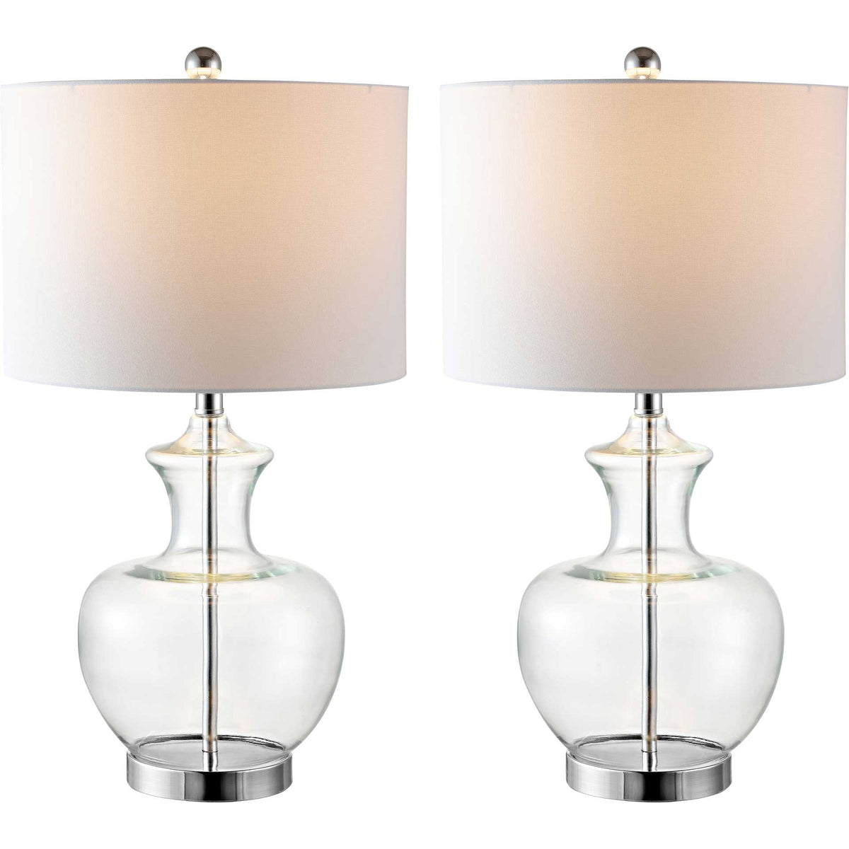 Two clear glass table lamps glow warmly beneath white drum shades with polished chrome finials
