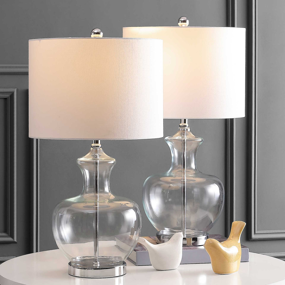 Matching glass lamps add warm ambient light with glowing white shades and gleaming chrome bases