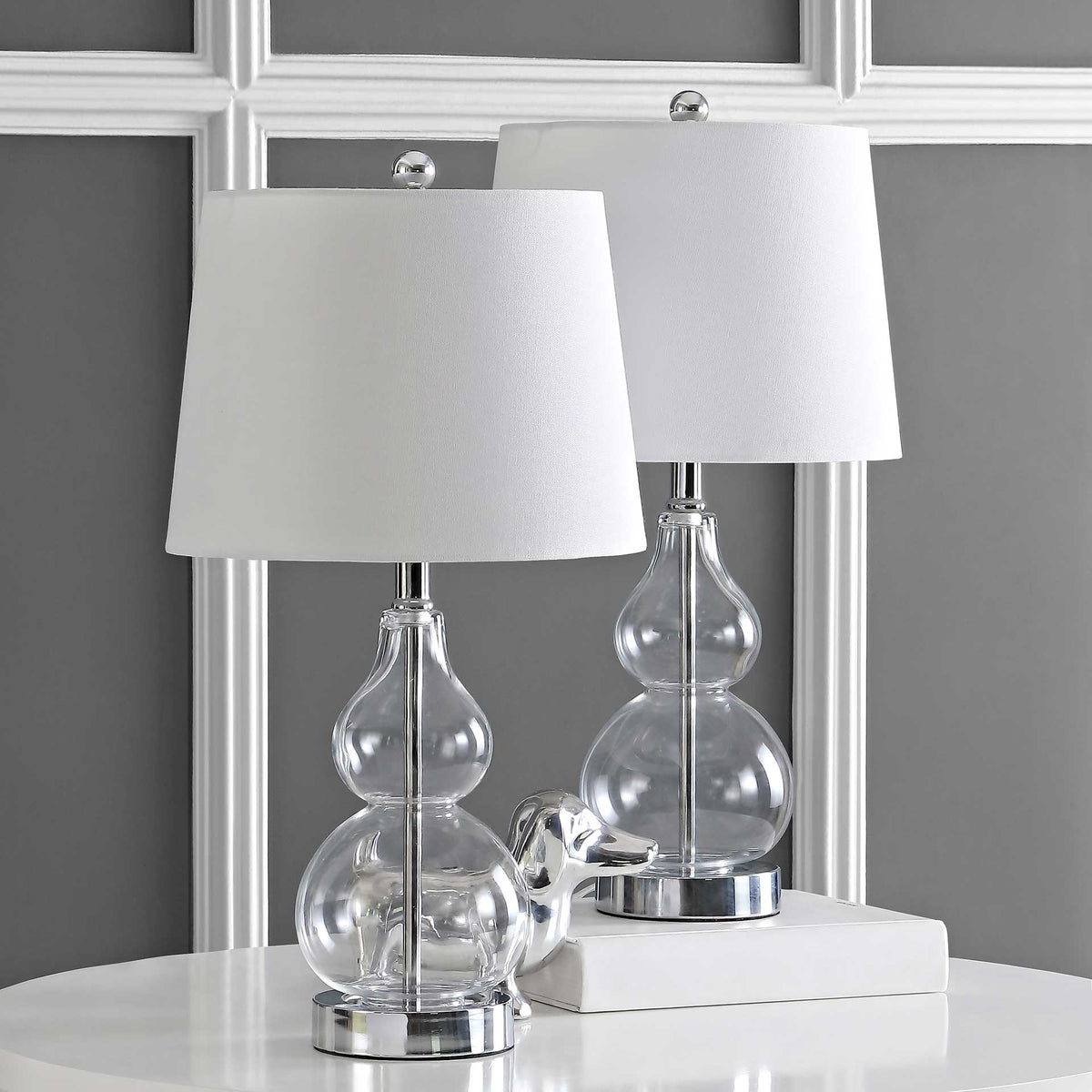 Clear glass table lamps add airy elegance with polished chrome bases and crisp white shades. || TBL4222A-SET2 || front_multi_room