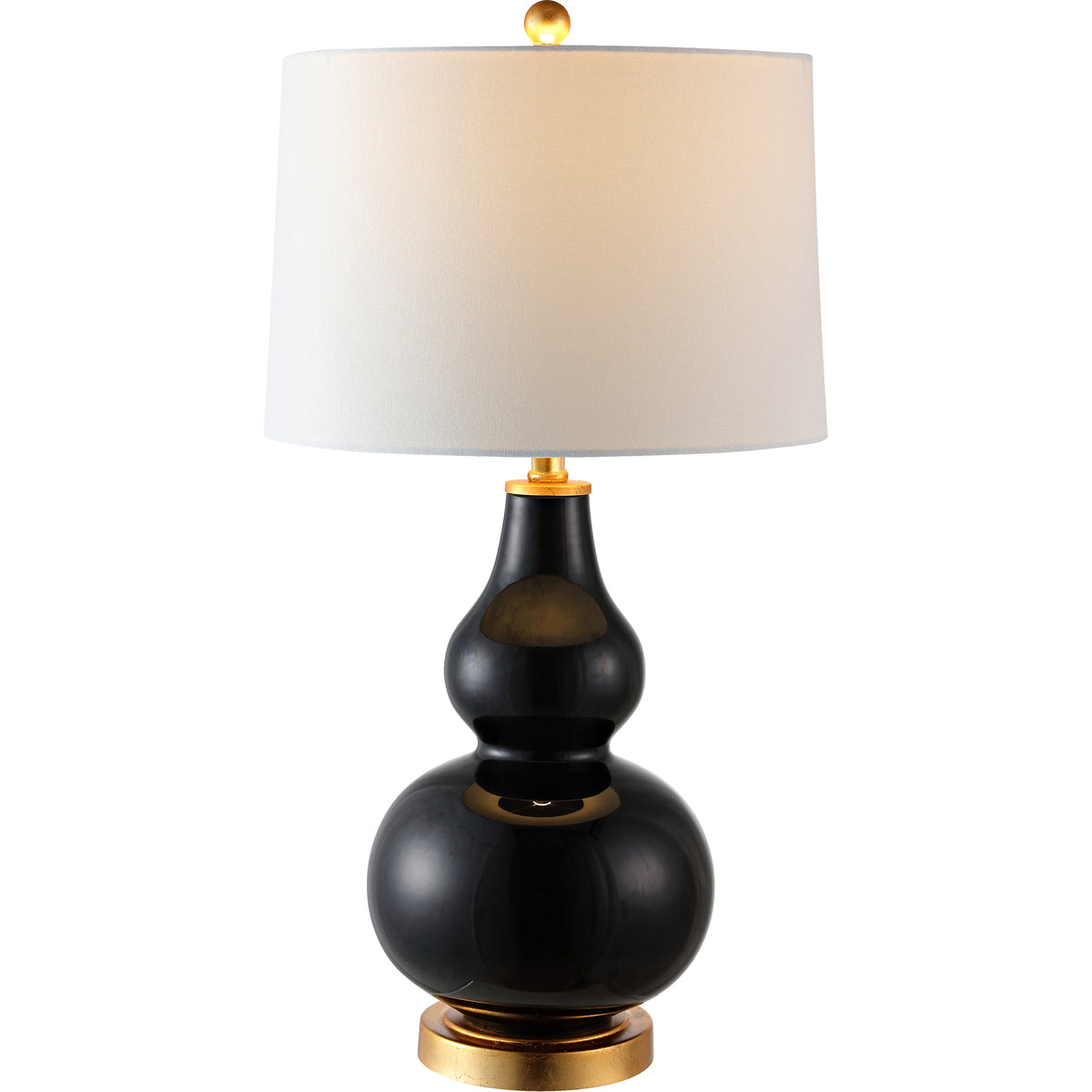 Warm light filters through a white fabric shade above a glossy black glass base with gold-tone trim.