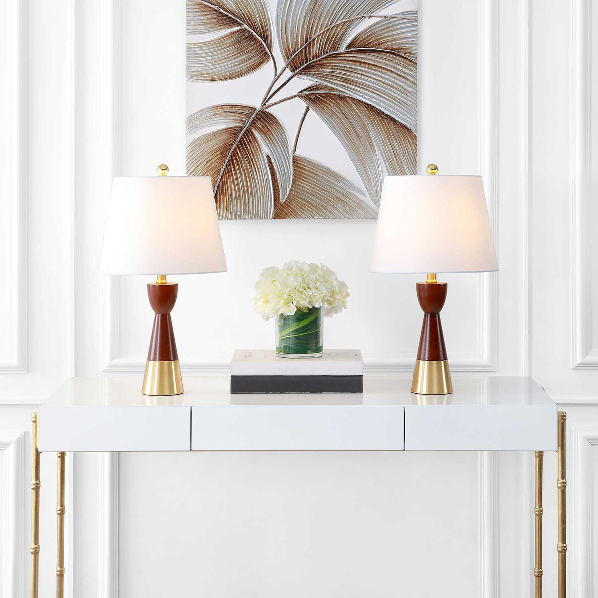 A matching pair casts a soft glow from white shades above warm brown-and-gold bases