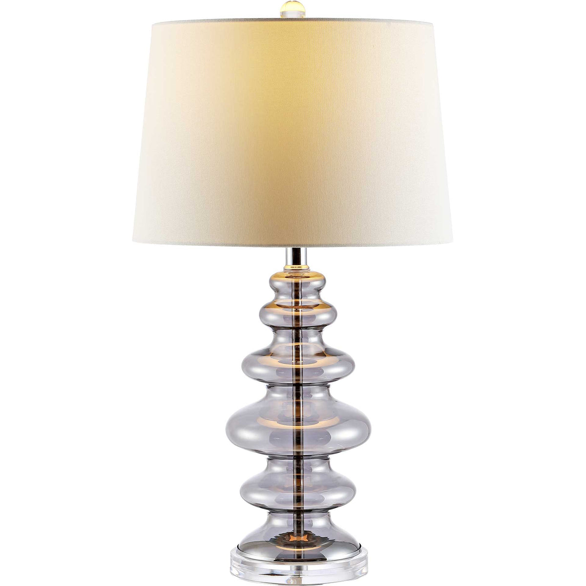 A warmly glowing white shade crowns the stacked gray glass base and clear finial.