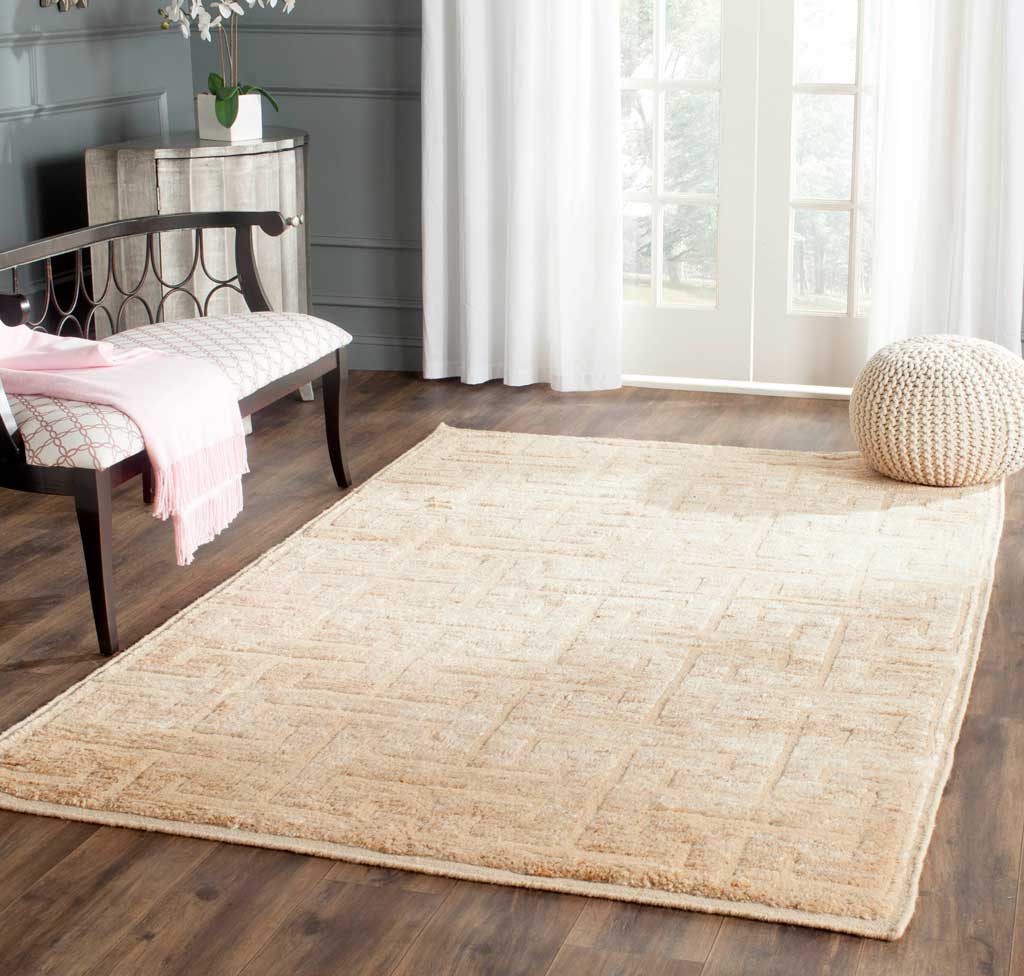 Soft ivory and beige geometric rug lends an understated look to a bright living space