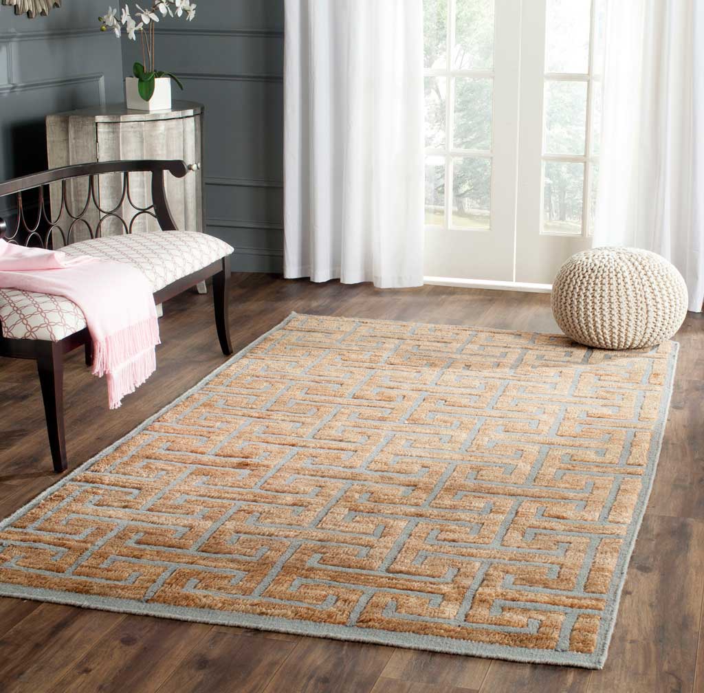 Gray geometric lines bring definition to a warm beige rug in a cozy living space