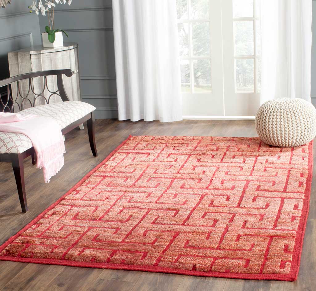 Vivid red geometric rug adds warmth and patterned texture to a bright living space