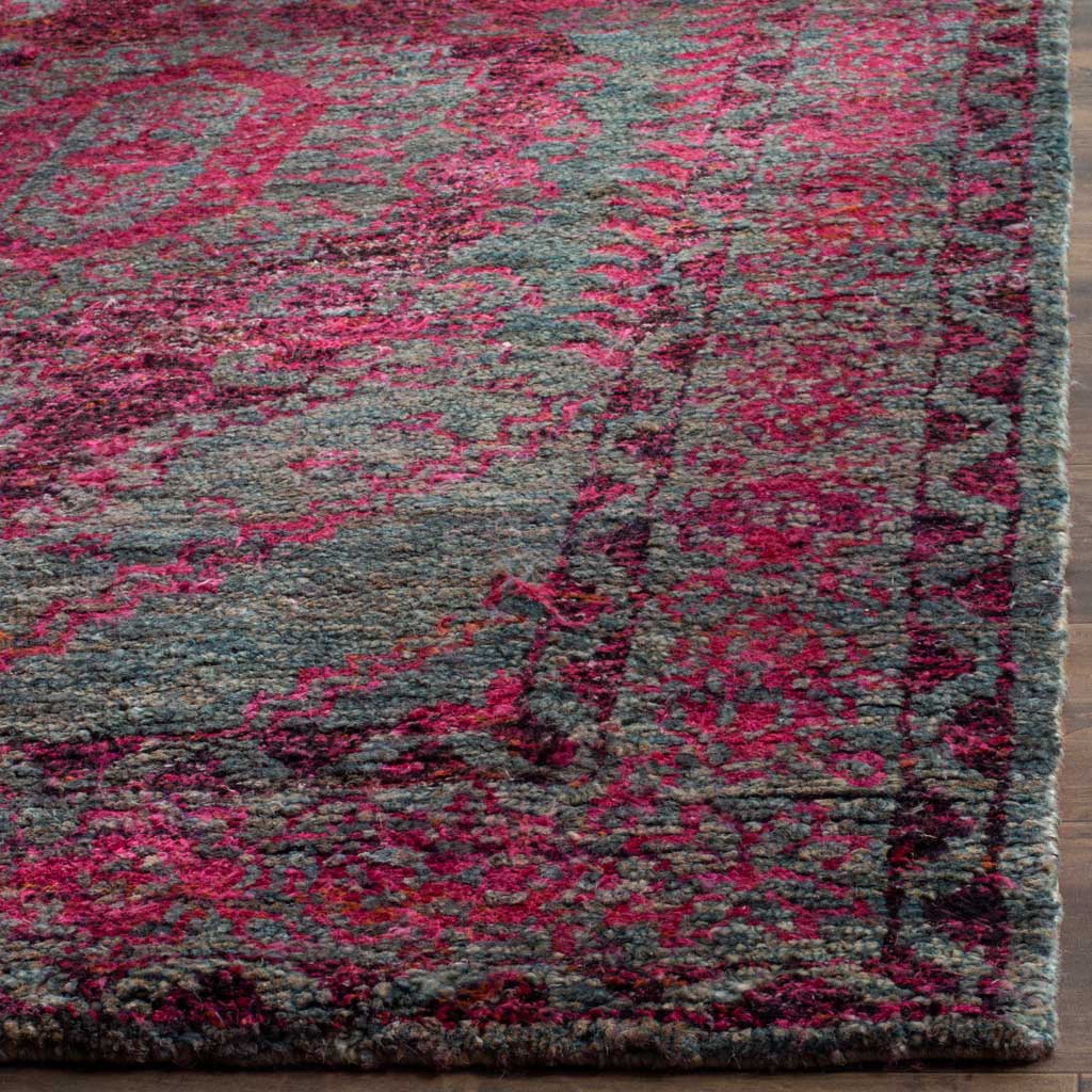 Dense fuchsia motifs and slate blue fibers create a richly textured rug corner