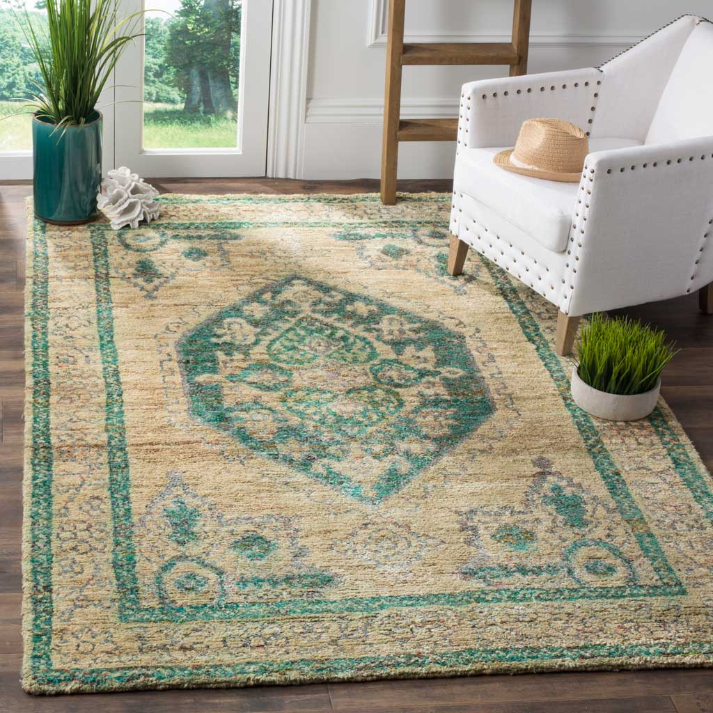 A beige and emerald medallion rug anchors the room with a textured finish and ornate border