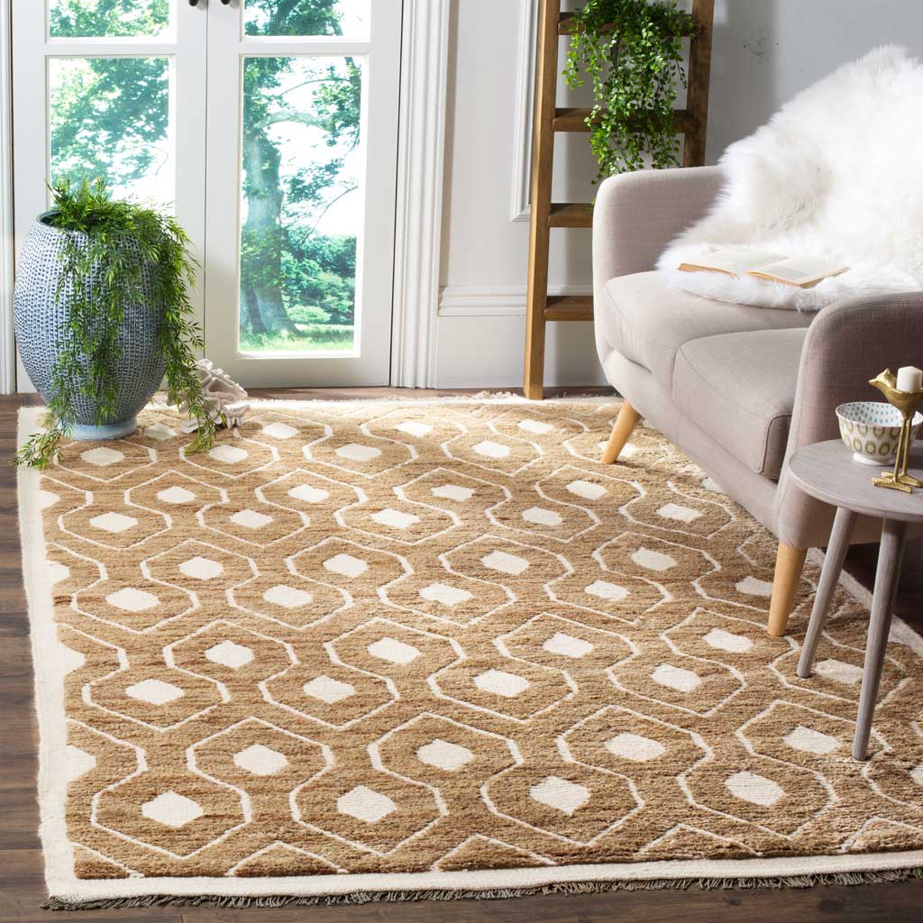 A warm tan rug with ivory geometric shapes and soft fringe adds texture to a living space