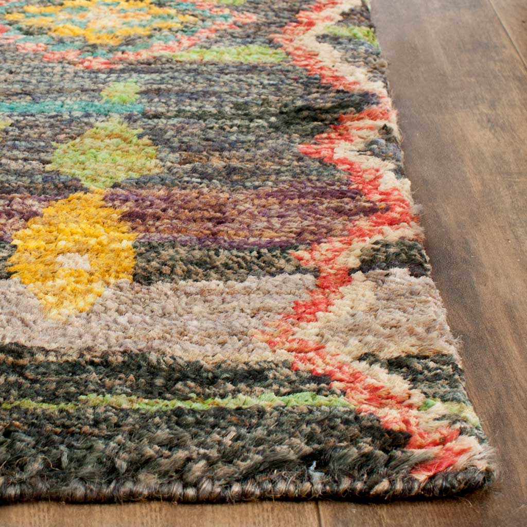 Thick, textured rug fibers meet a coral zigzag border and colorful woven motifs