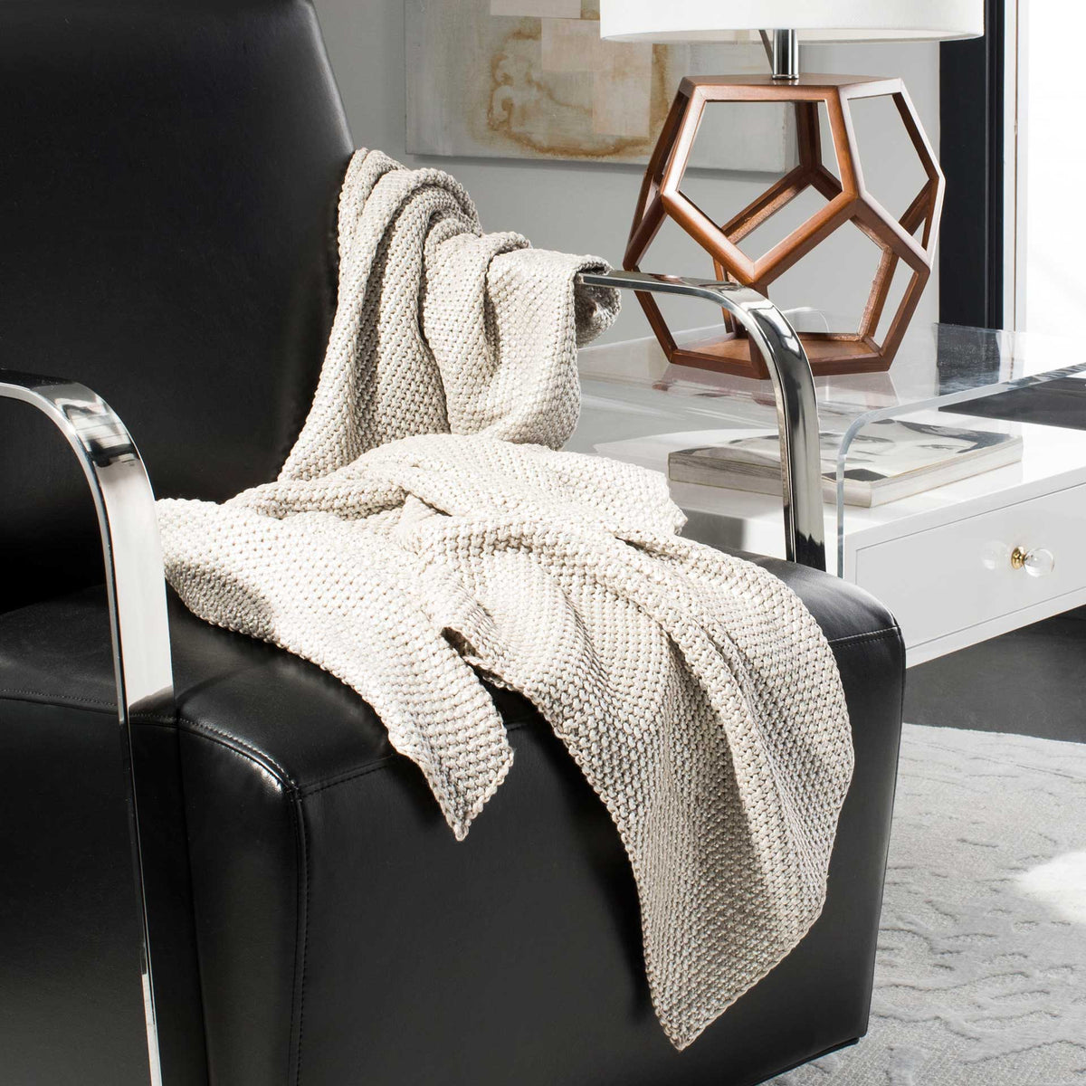 Textured gray cotton throw draped over an armchair for a relaxed, cozy accent