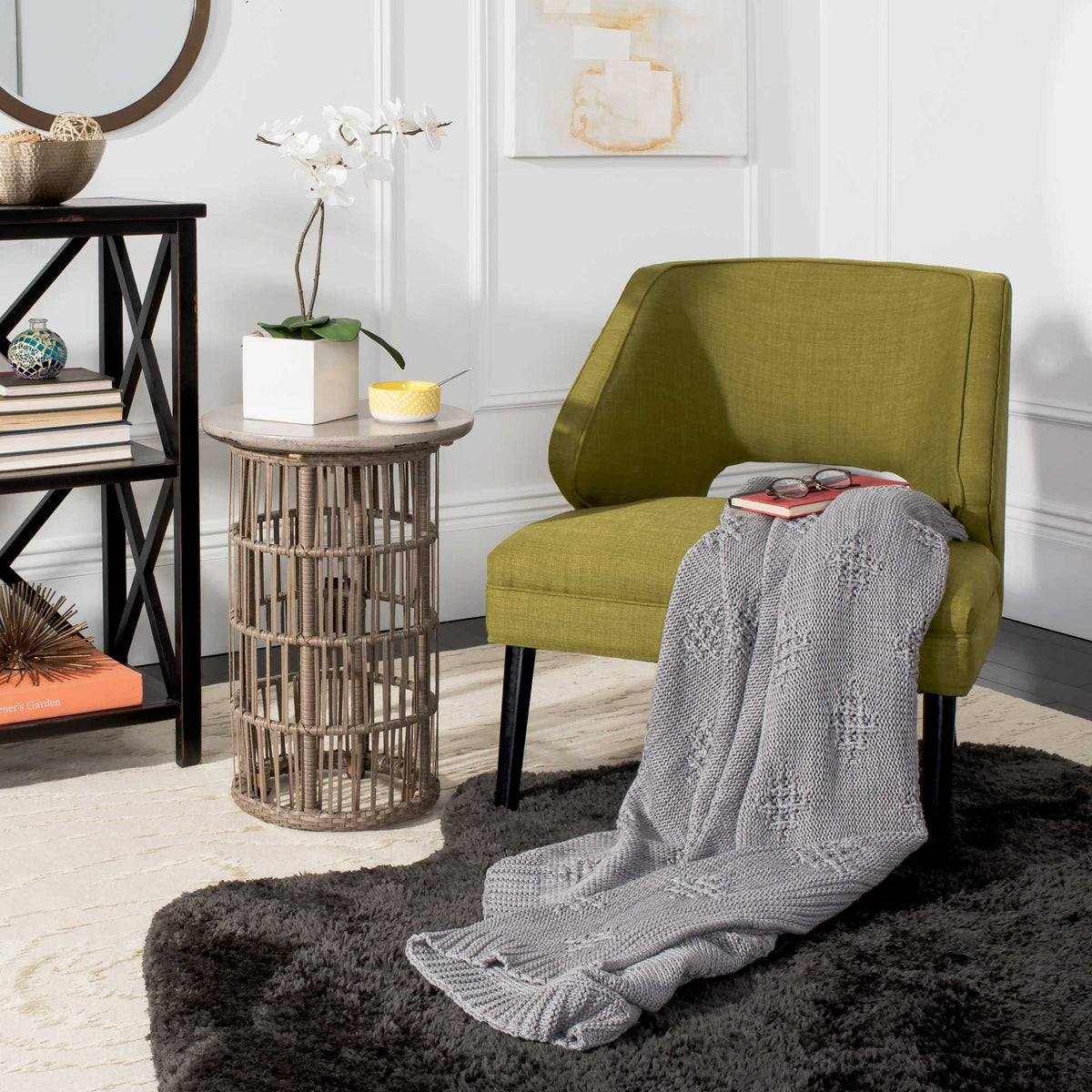 Textured gray knit throw draped over a chair adds warmth to a living room