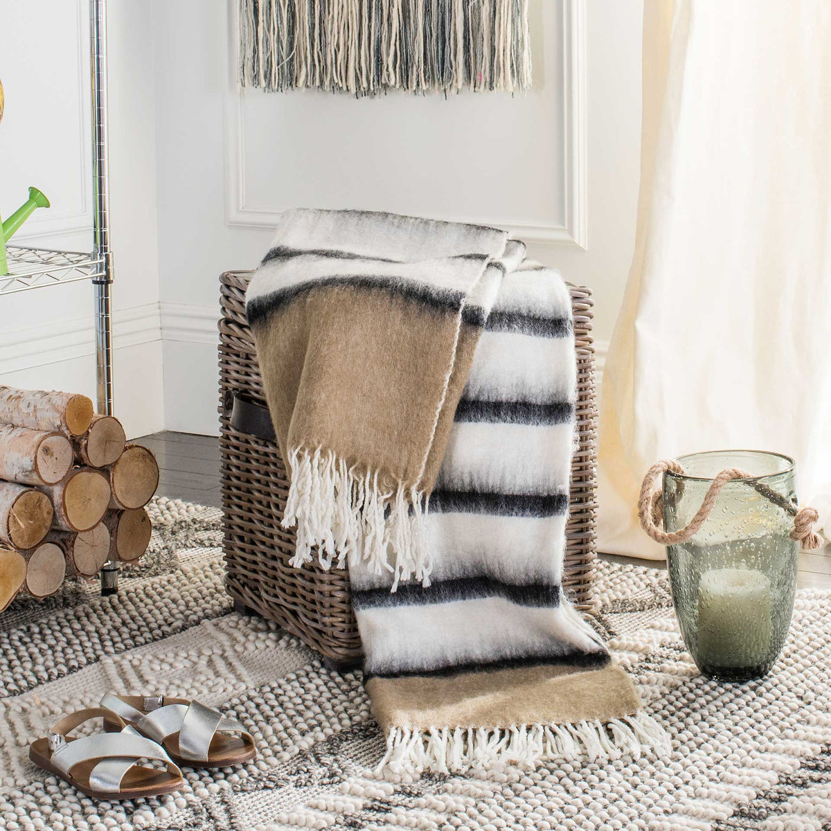 Brown and cream striped throw draped over a woven basket, with fringed ends adding cozy texture