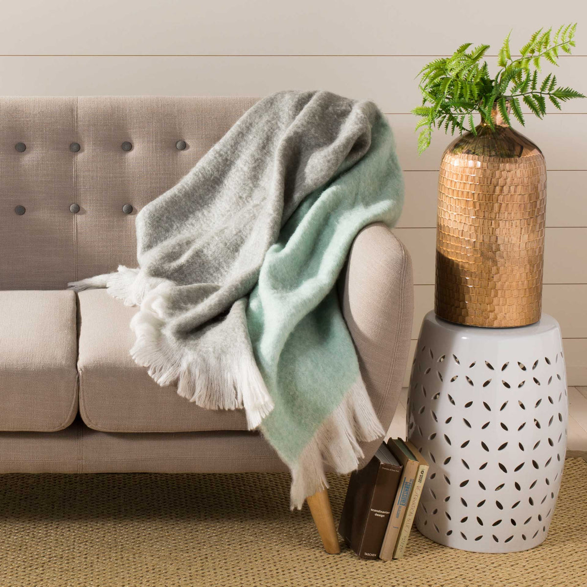 Cozy gray and aqua throw adds soft texture and flowing ivory fringe to a sofa