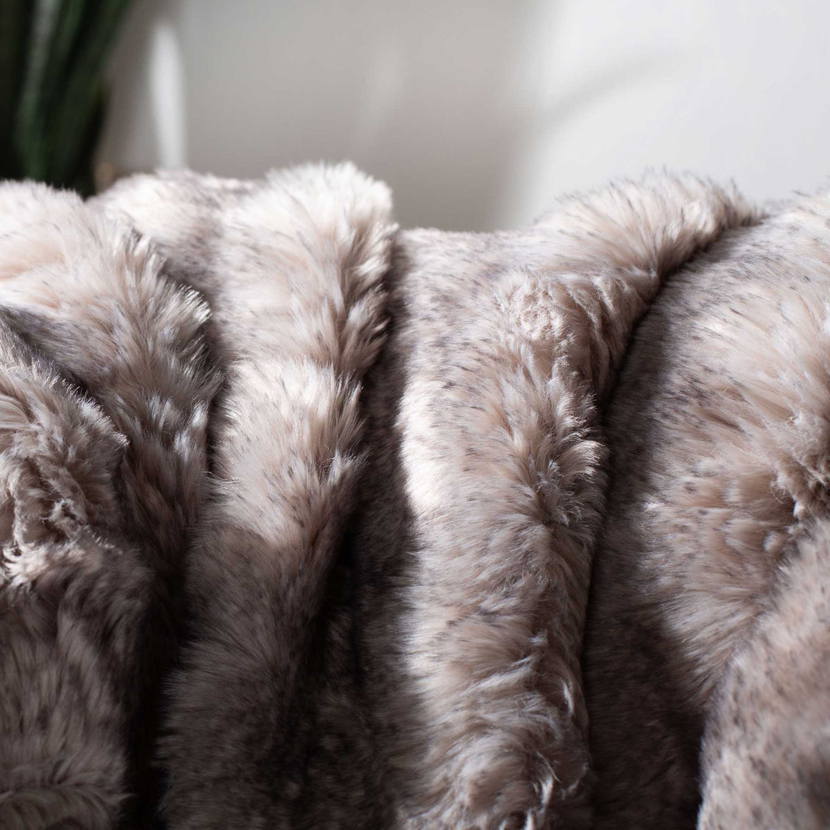 Silvery gray fibers create a soft, chinchilla-inspired texture.