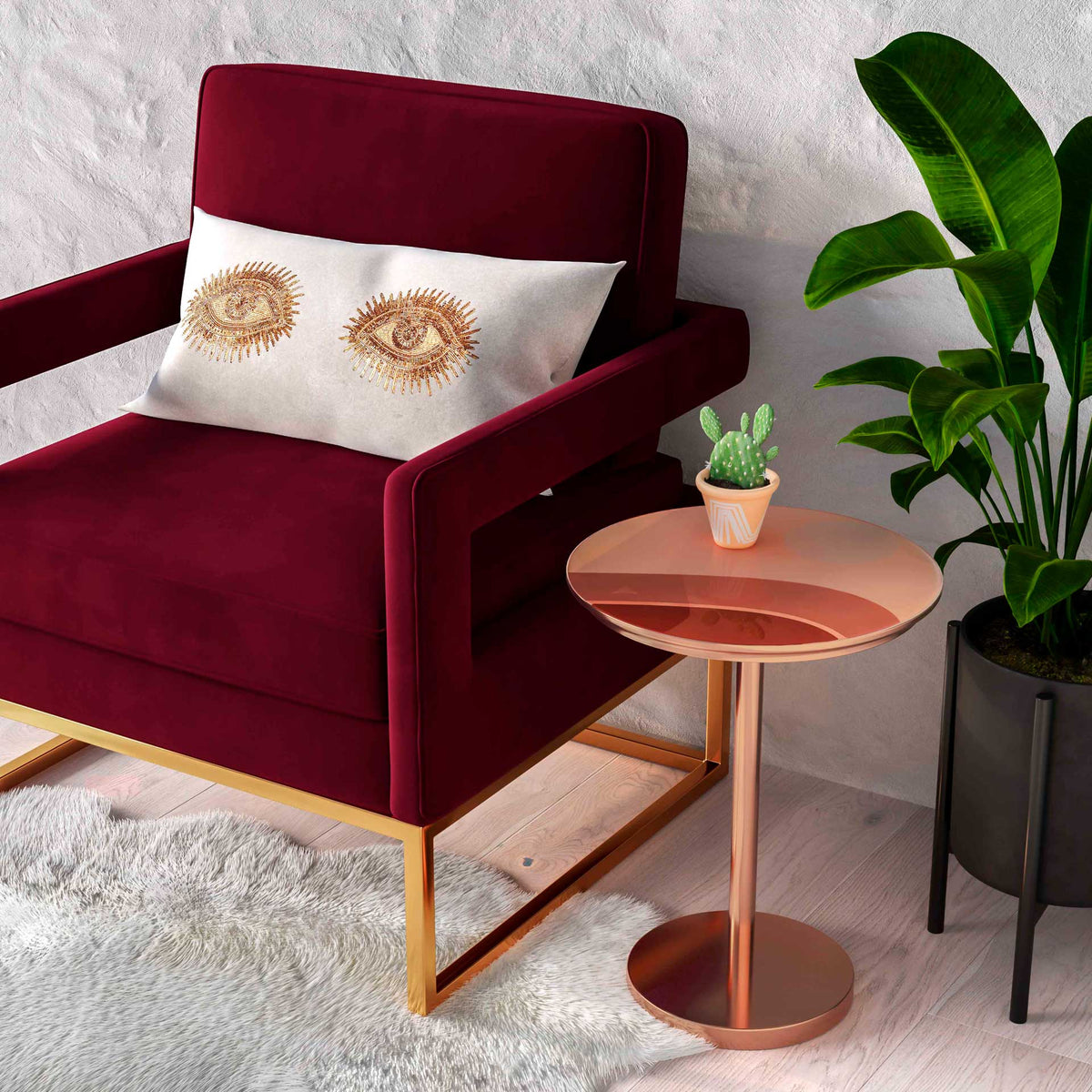 Maroon velvet upholstery, crisp piping, and padded arms add rich texture to an inviting seating corner.