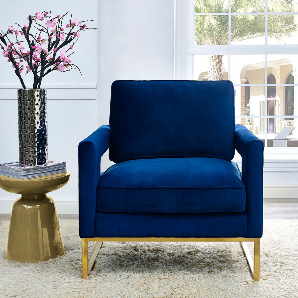 Deep navy velvet and warm gold sled legs create an elegant spot to settle in beside a sunny window.