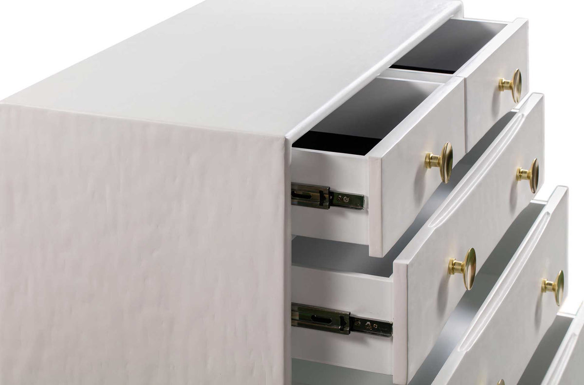 Small upper drawers provide organized storage with white interiors, metal slides, and brass knobs