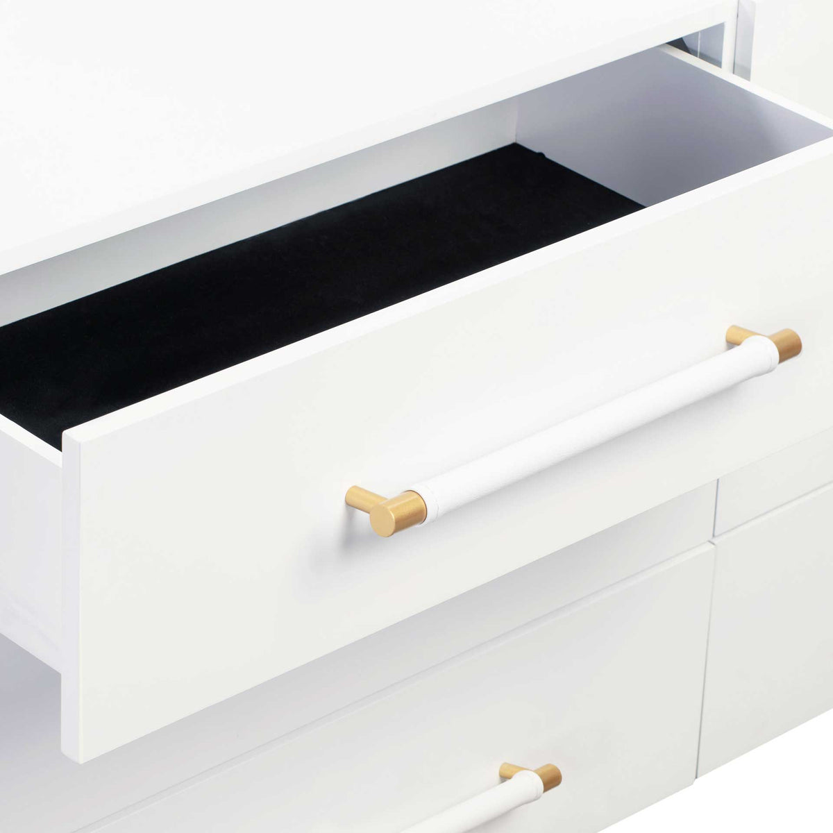 A spacious white drawer reveals a dark interior and a matching pull with brass accents