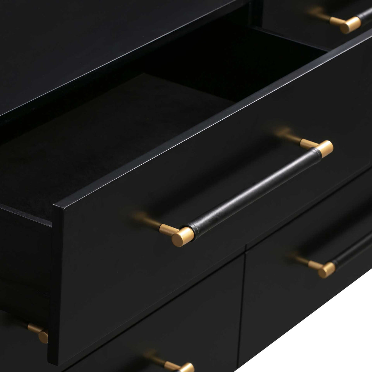 Roomy black drawer storage pairs with a vegan leather-wrapped pull and warm brass accents
