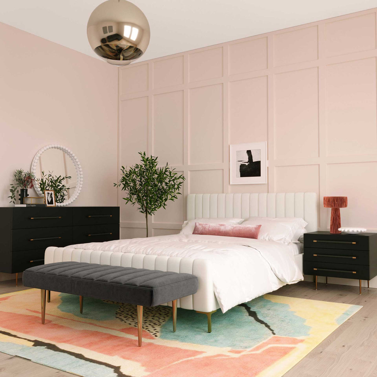 Black drawer fronts and gold-accented pulls bring tailored style to a light, airy bedroom