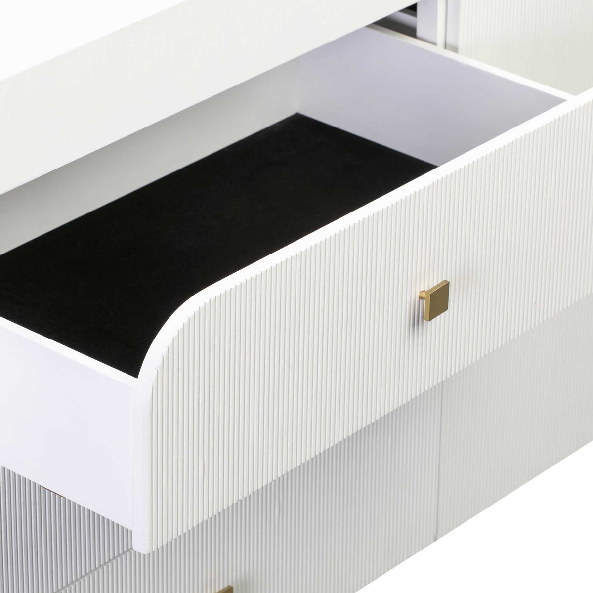 A roomy drawer with a dark base features a fluted white front and a square gold-tone knob.