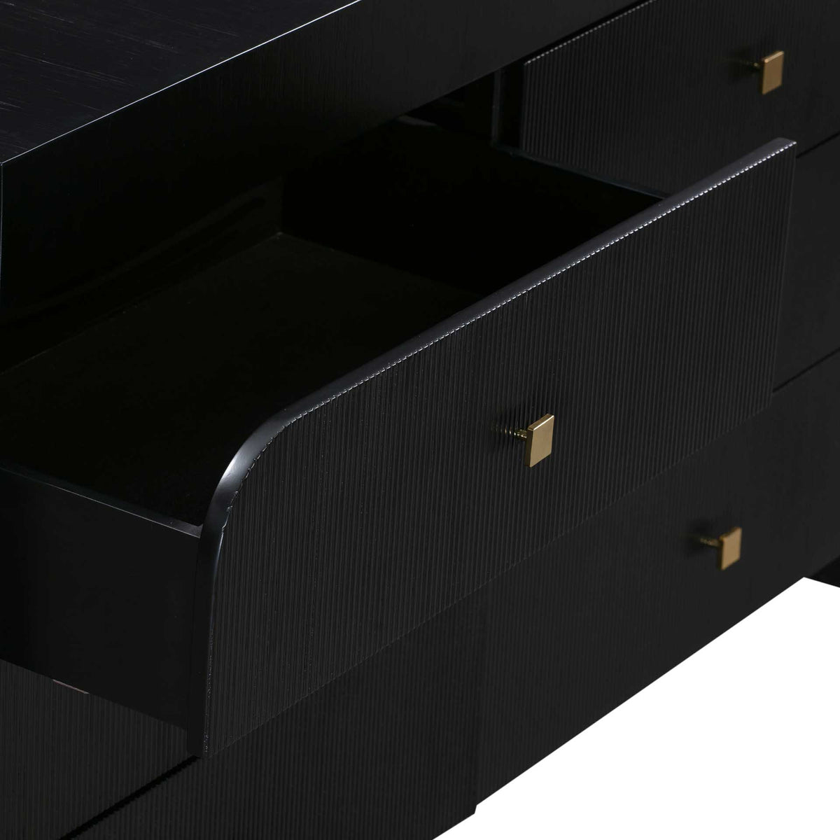 A spacious black drawer pairs a rounded, fluted front with a square gold-tone knob for stylish storage.