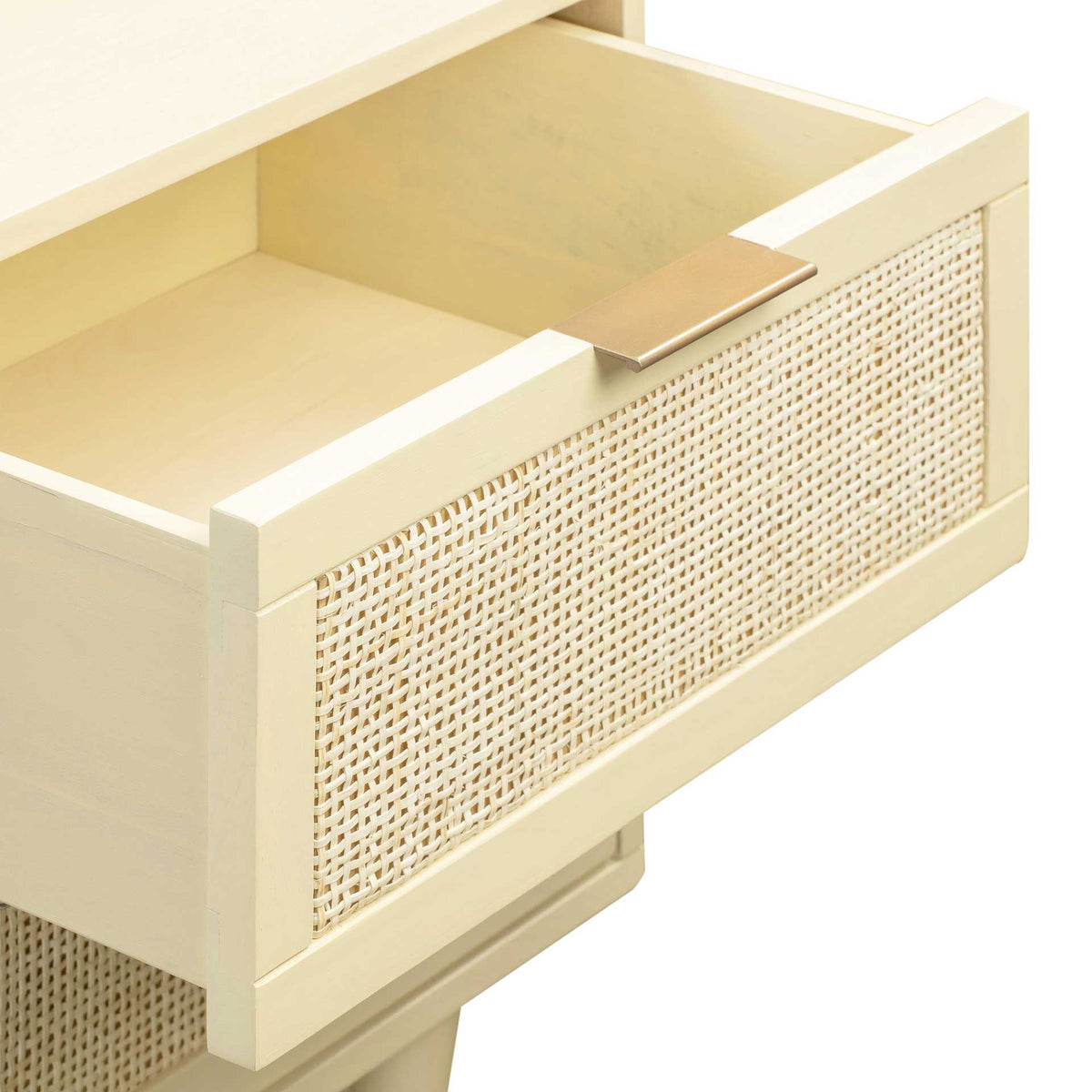 A roomy cream drawer combines a woven cane front with a broad brass-tone tab pull