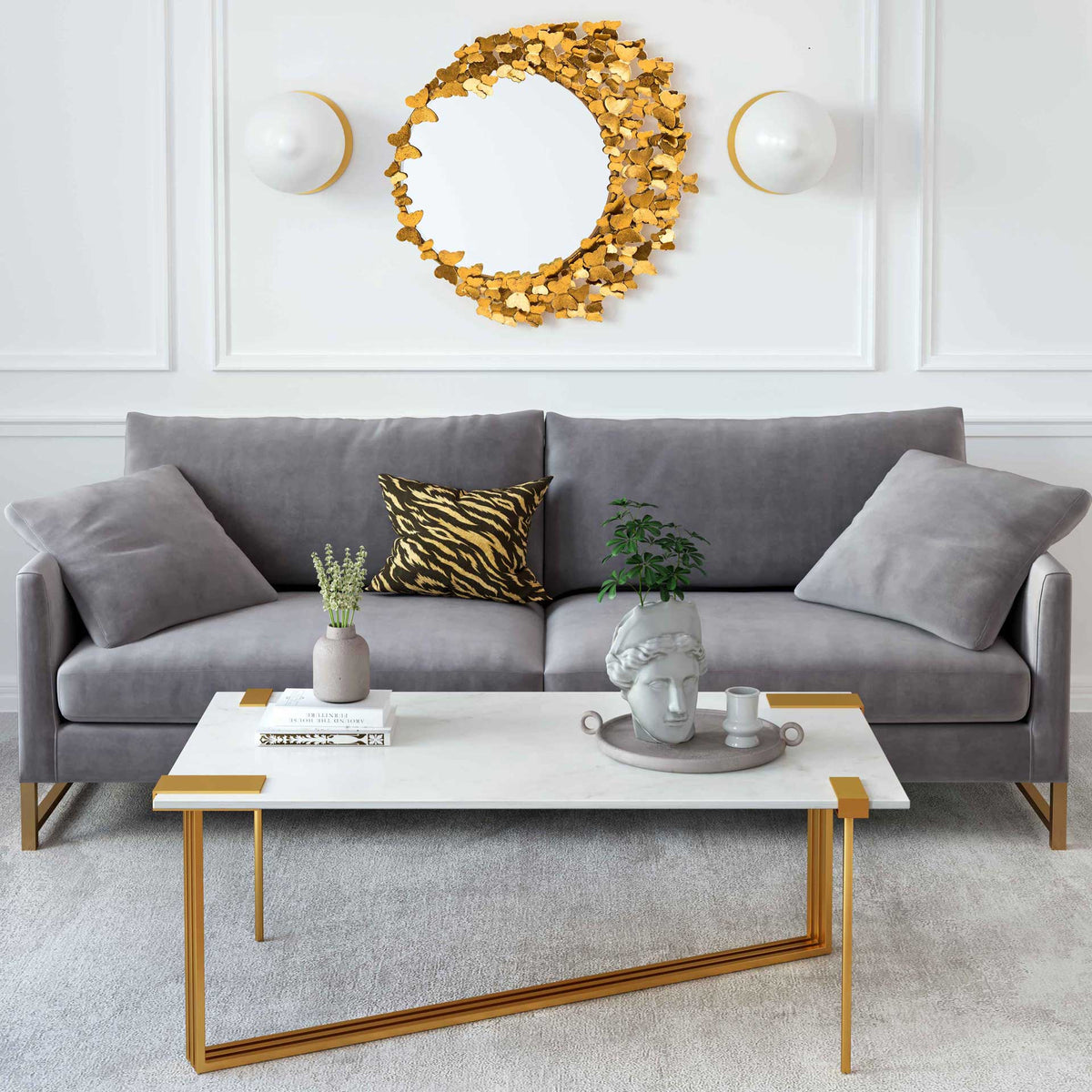 A gold butterfly mirror brings a whimsical focal point above a gray sofa in a bright living room