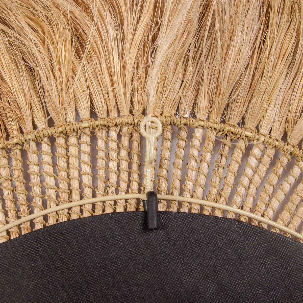 A hanging loop and knotted abaca fibers combine practical function with handcrafted texture