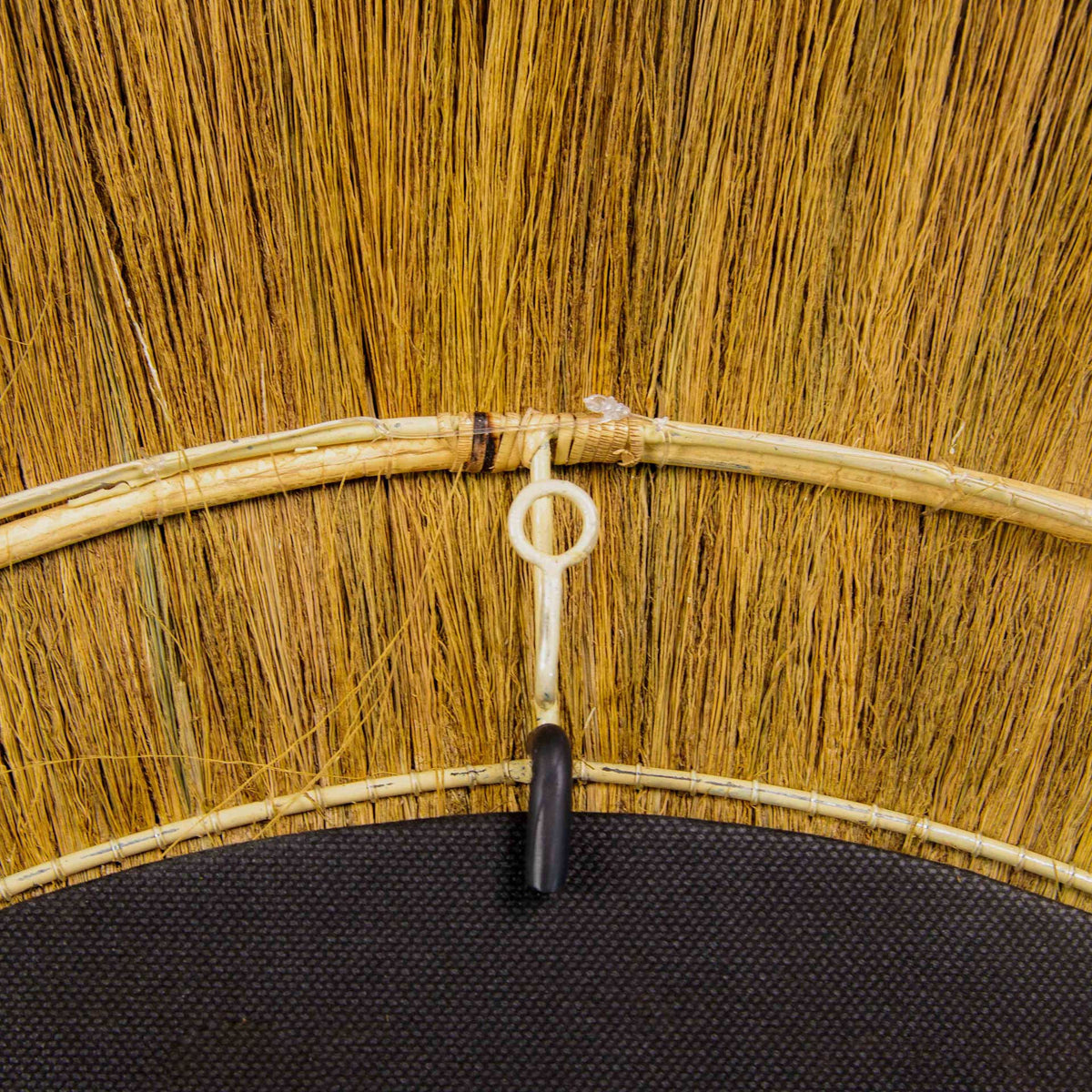 Integrated hanging loop and bound natural fibers make this grass-framed mirror ready to hang