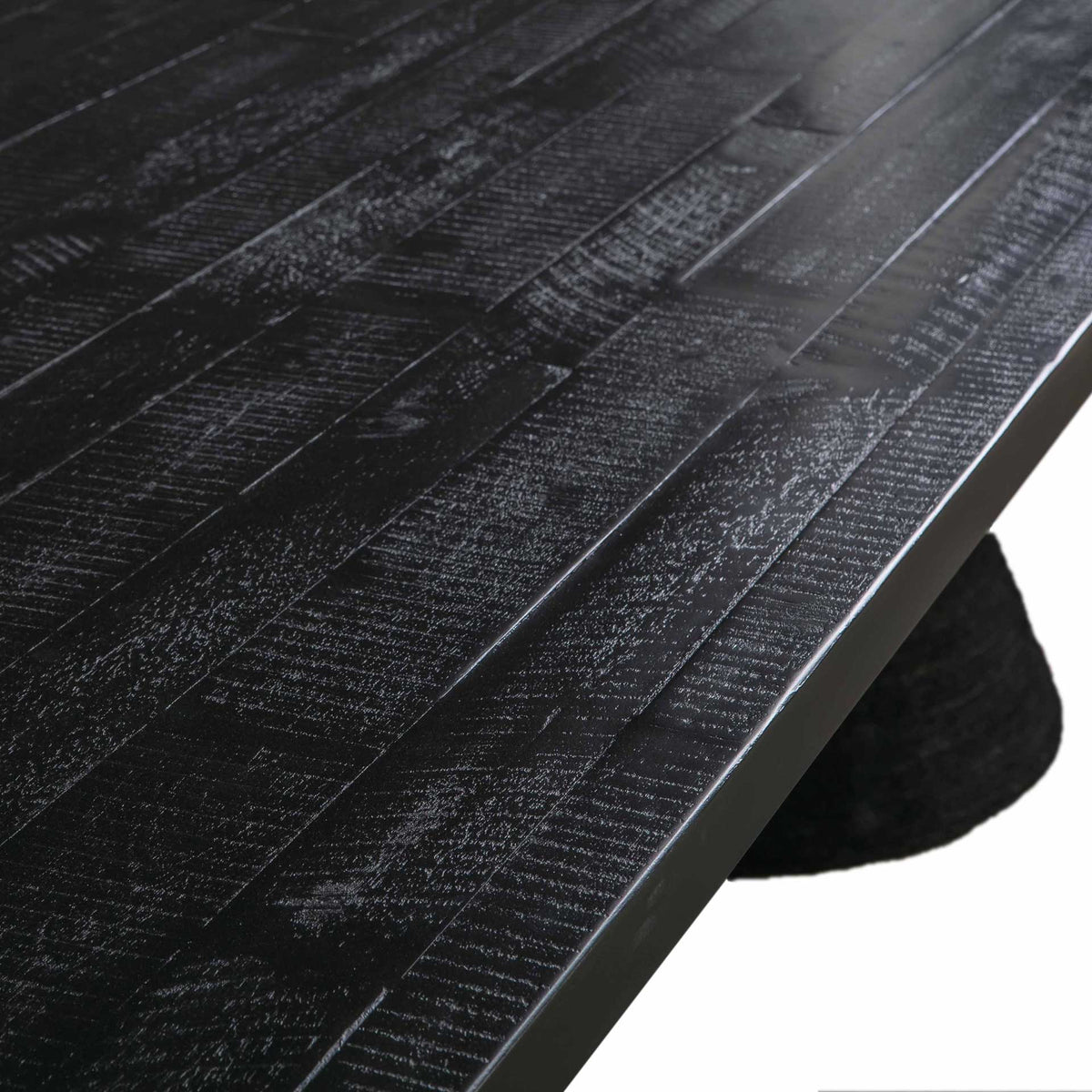 Textured acacia grain adds depth and character to the black tabletop's sleek finish