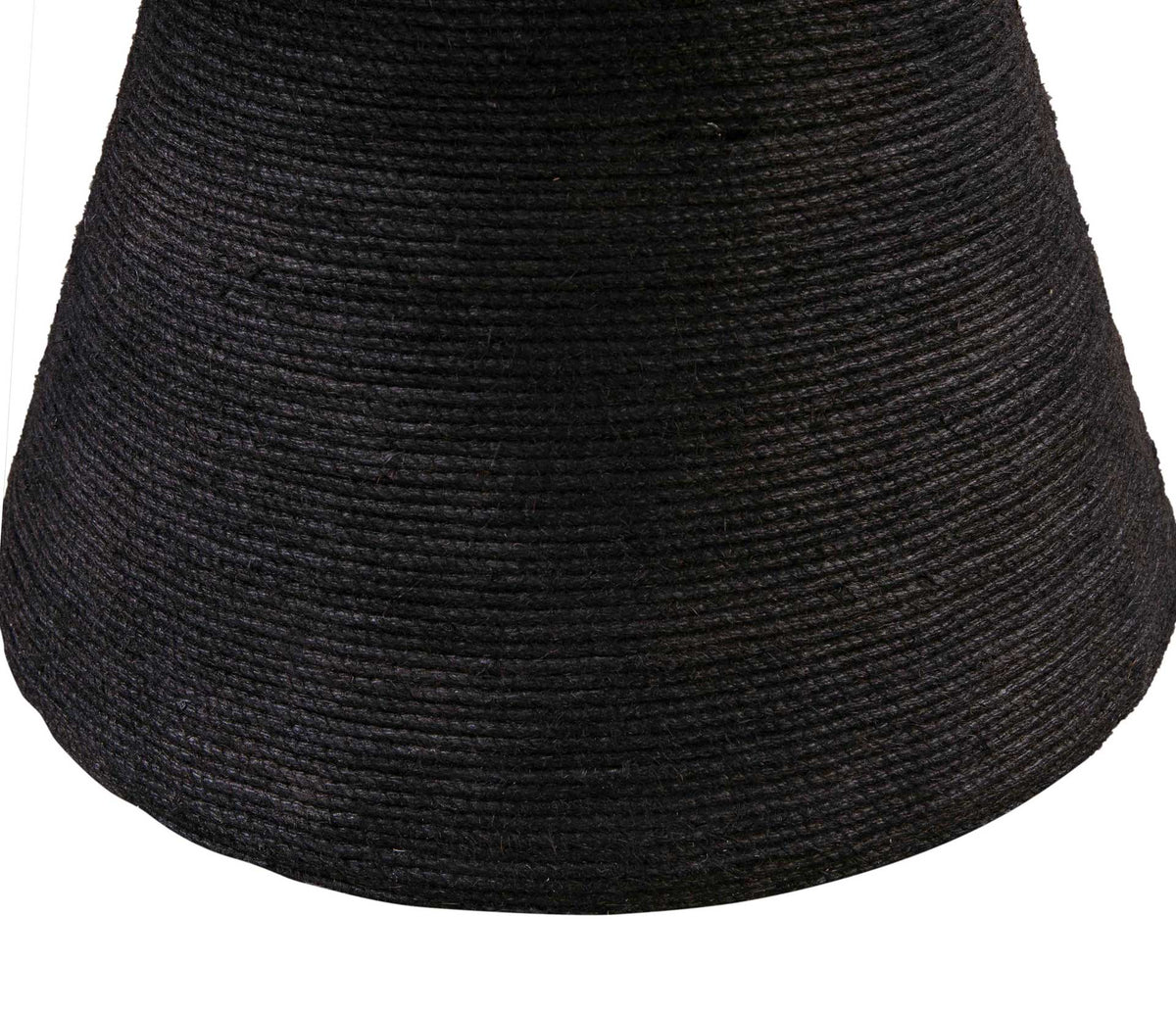 The flared pedestal's coiled black rope brings a bold, tactile element to the dining table