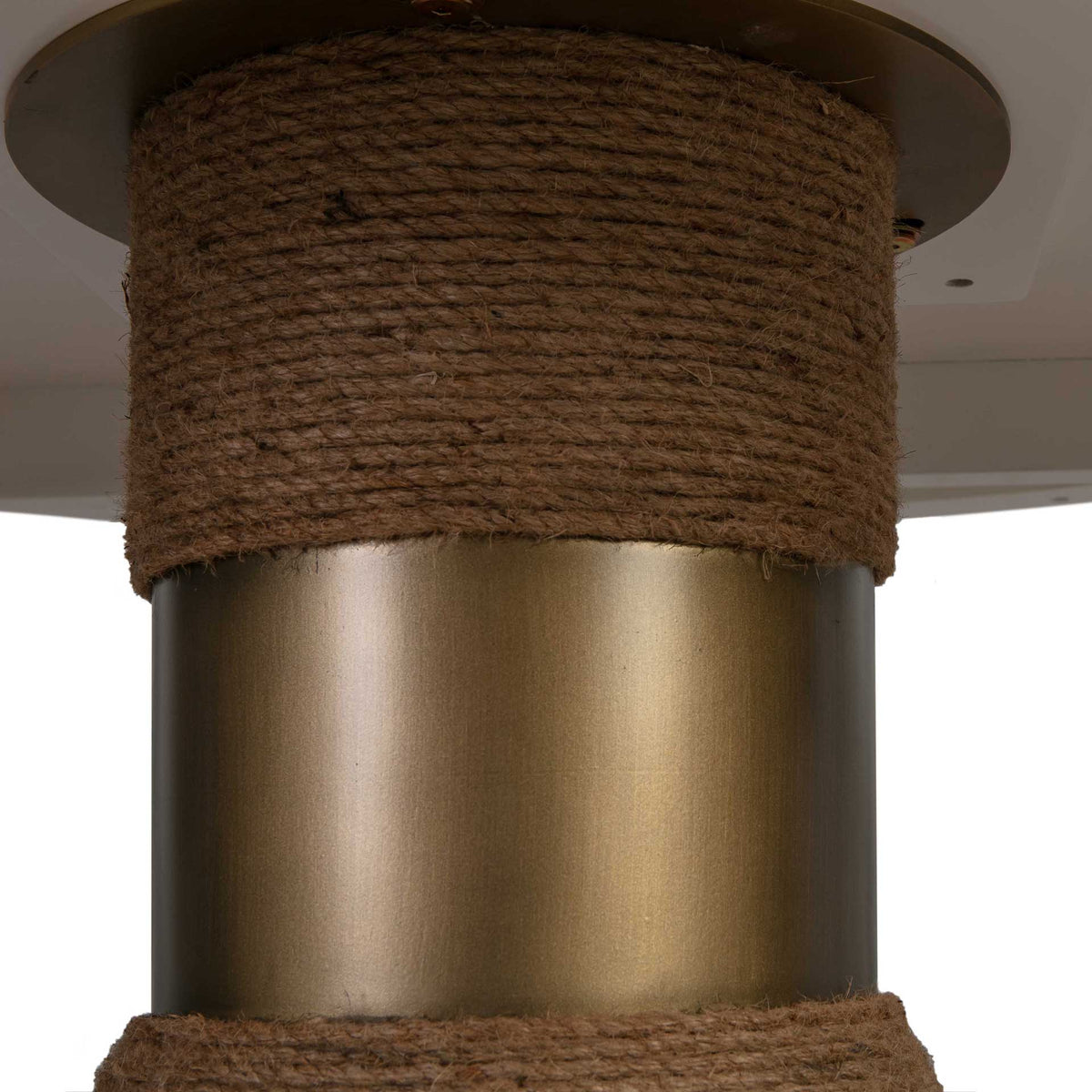A warm metallic collar contrasts with tightly wrapped natural rope for a refined coastal accent