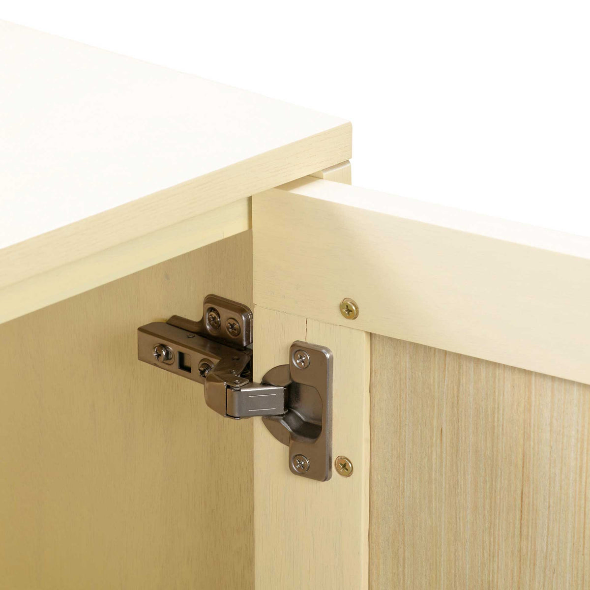 Concealed metal hinges secure the cane-paneled doors to a smooth cream-finished frame