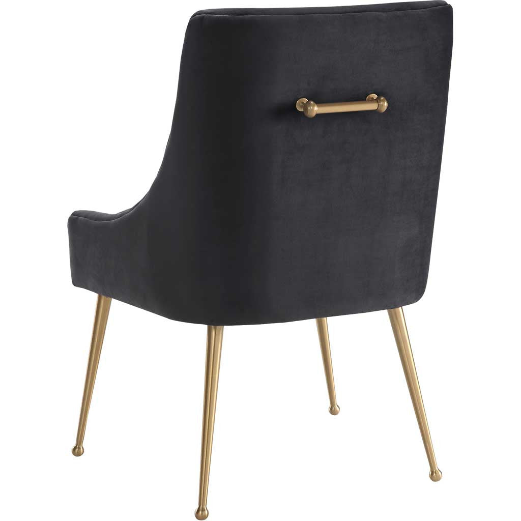 A smooth charcoal velvet back and gold pull bring tailored elegance to this curved dining chair.