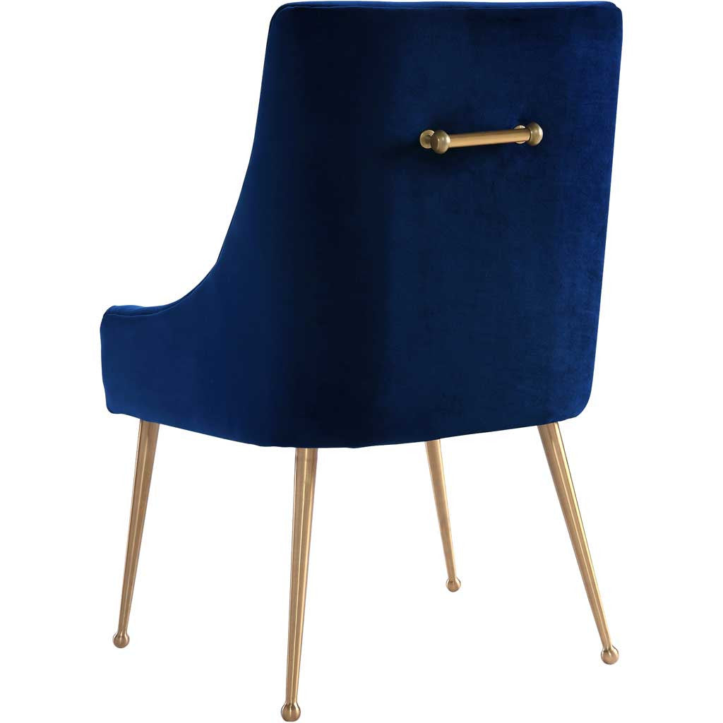 A gold handle accents the smooth navy velvet shell, while splayed gold legs lend a light, airy feel.