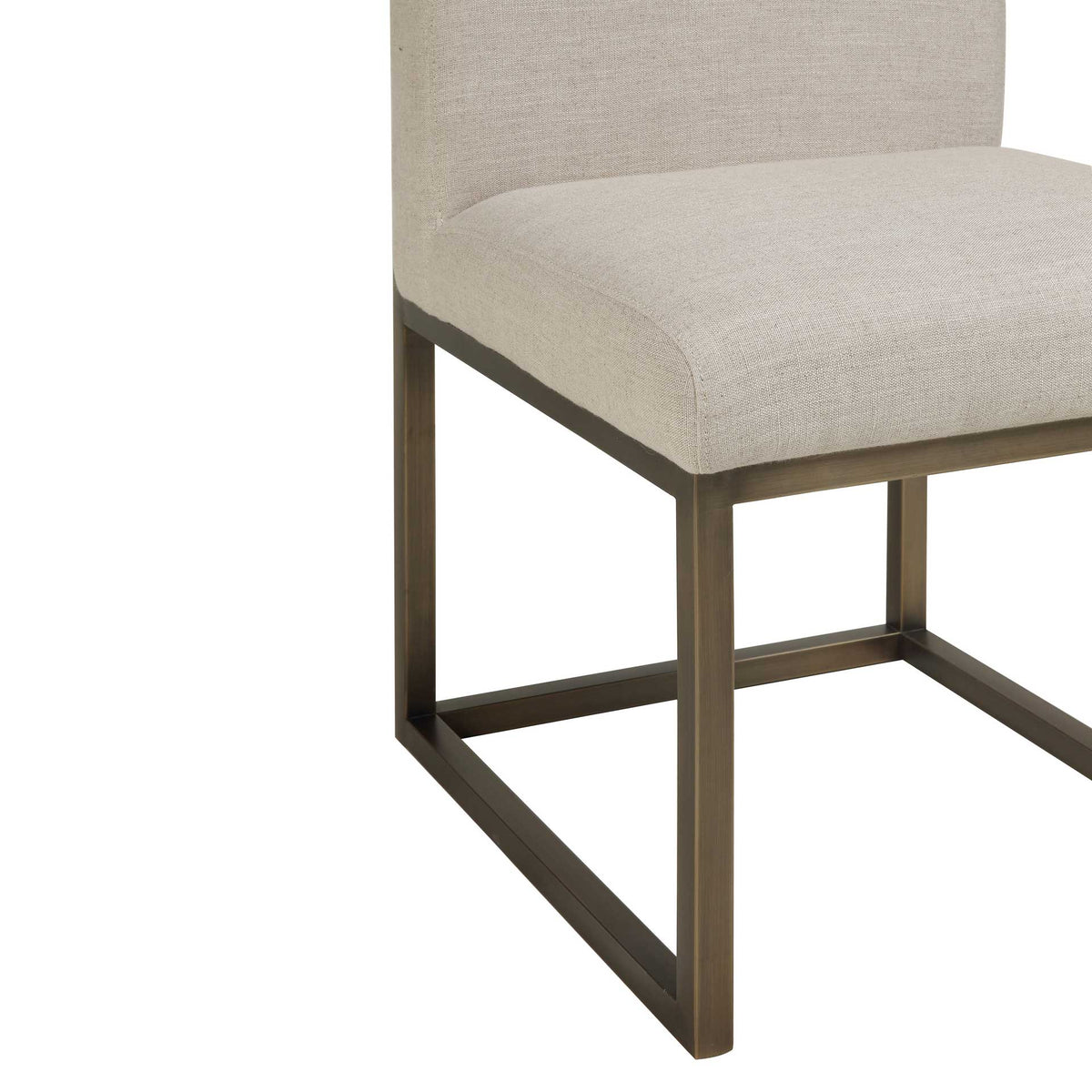 An open bronze-tone steel base adds geometric structure beneath the thick beige linen seat