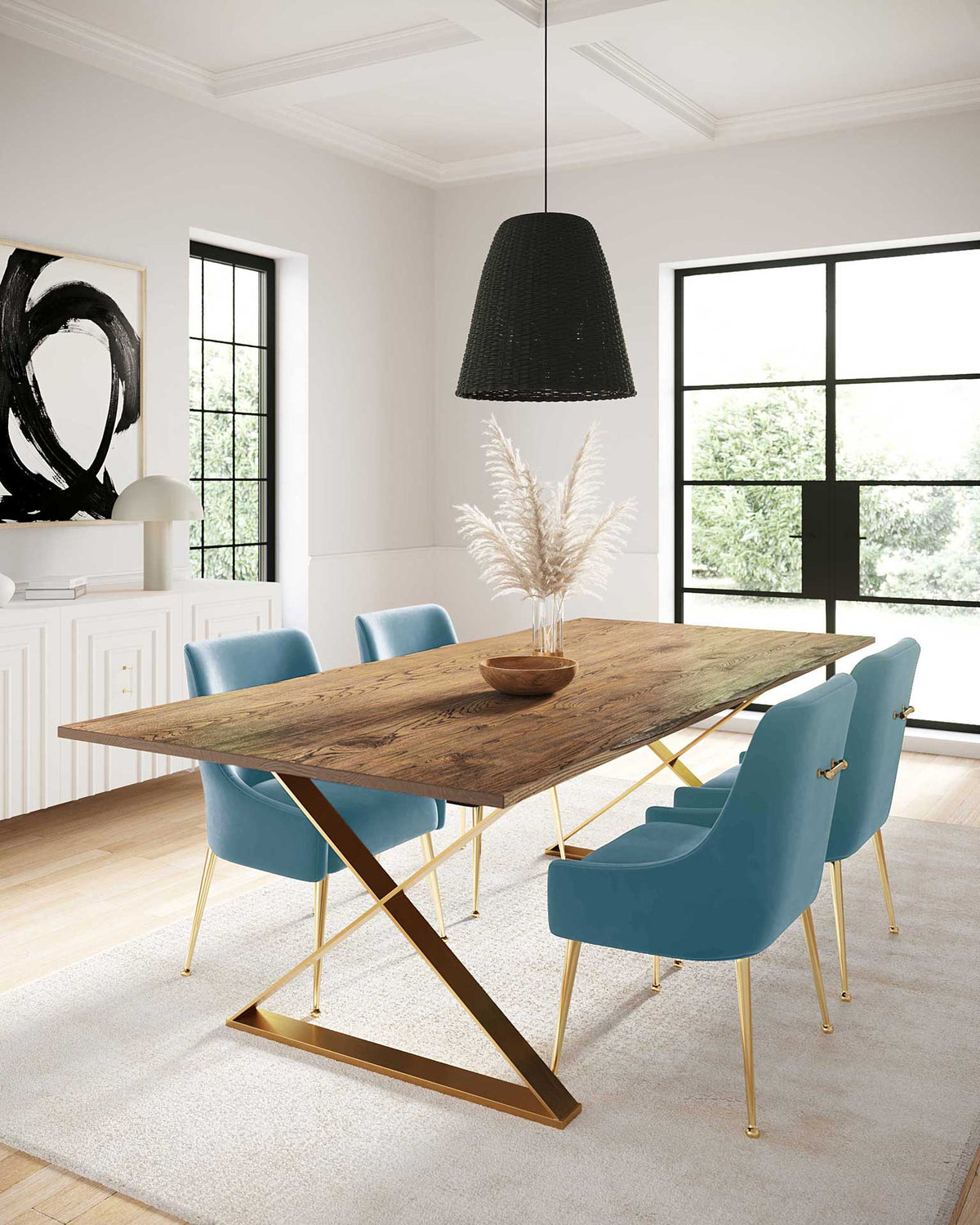 Soft sea blue velvet chairs and gold accents add a cool, elegant touch around a warm wood dining table.