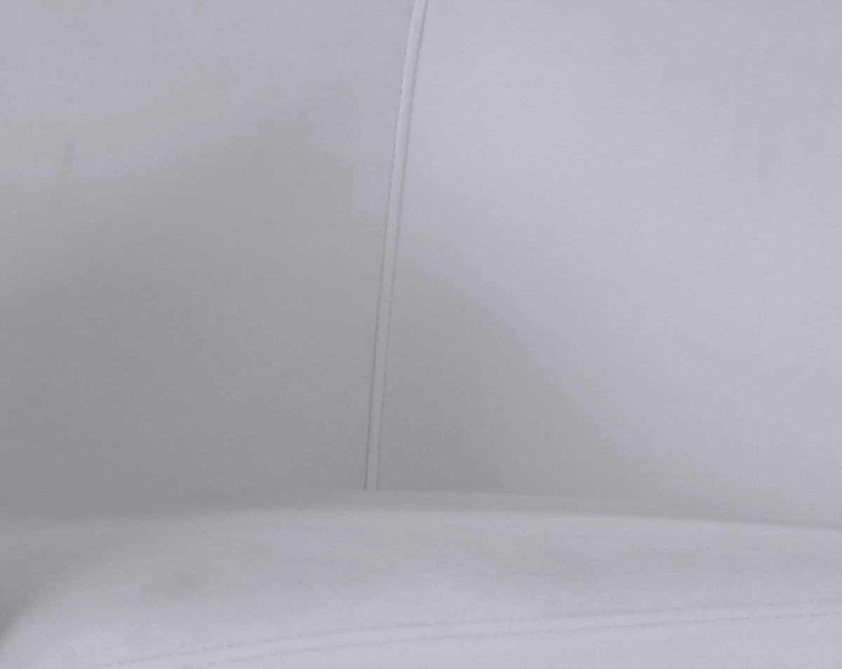 Soft gray velvet, a neatly stitched backrest, and a thick seat cushion offer a tailored, inviting feel