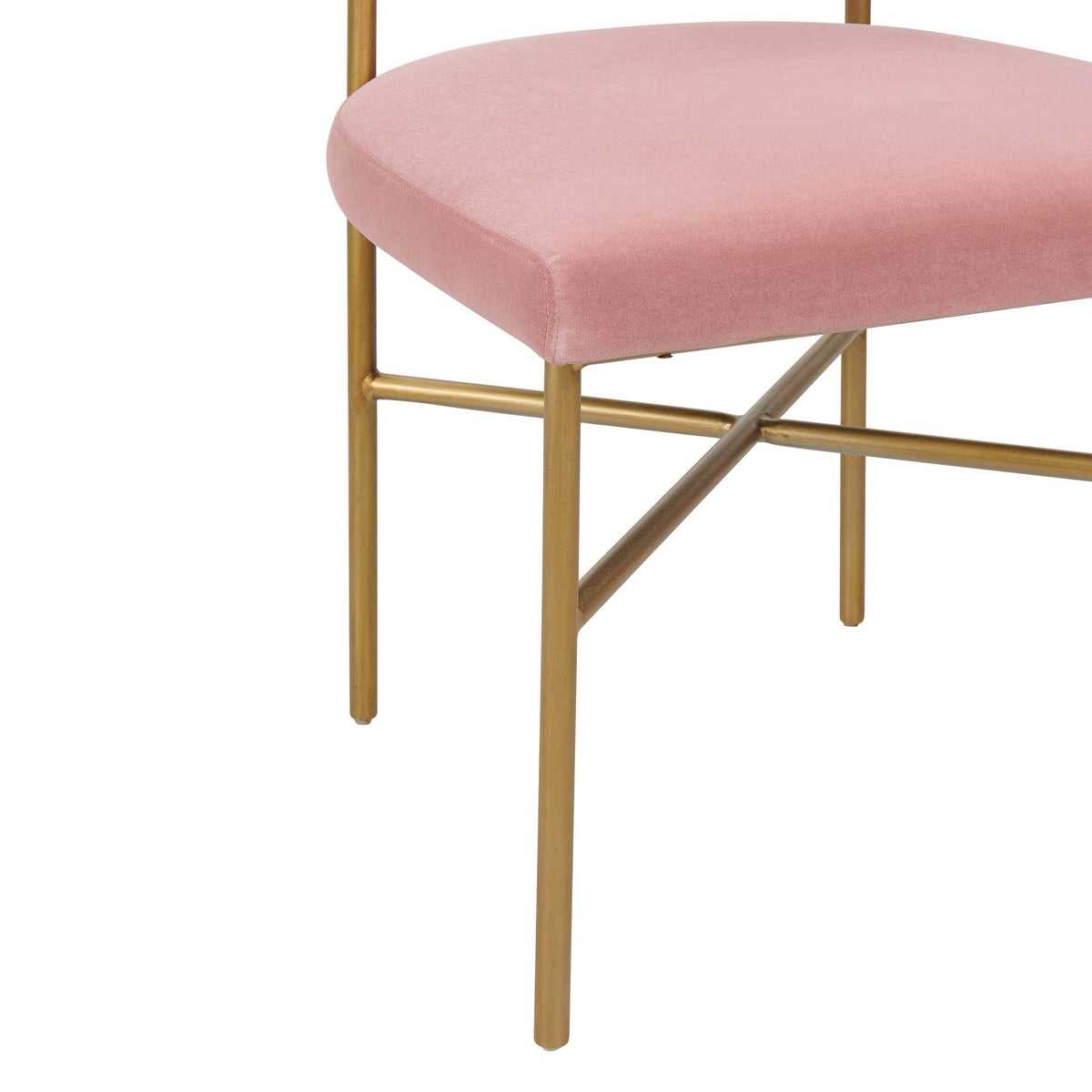 Slim gold legs and intersecting braces create an airy base beneath the blush velvet seat