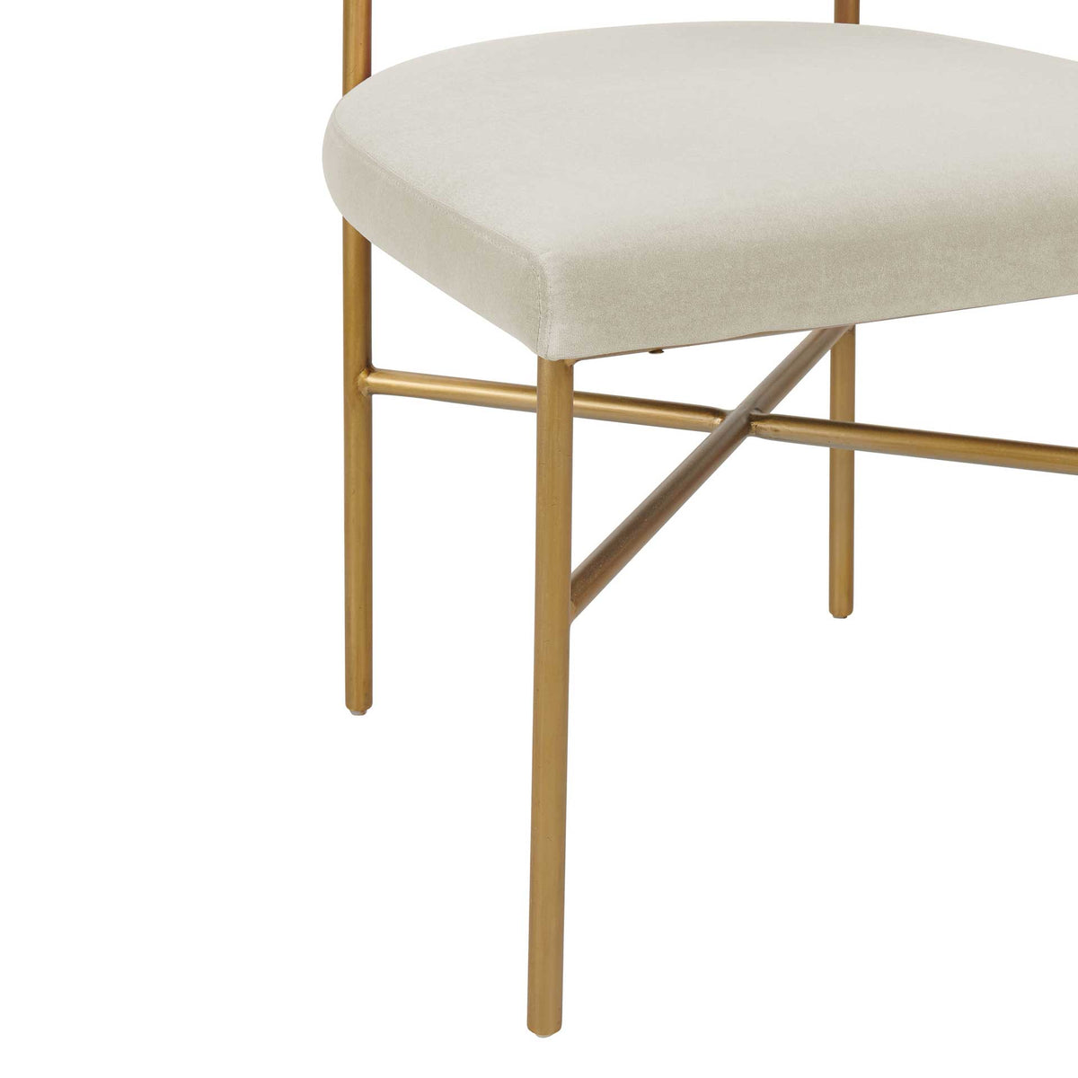 Gold-finished legs with crossing support bars add a delicate contrast to the plush cream seat