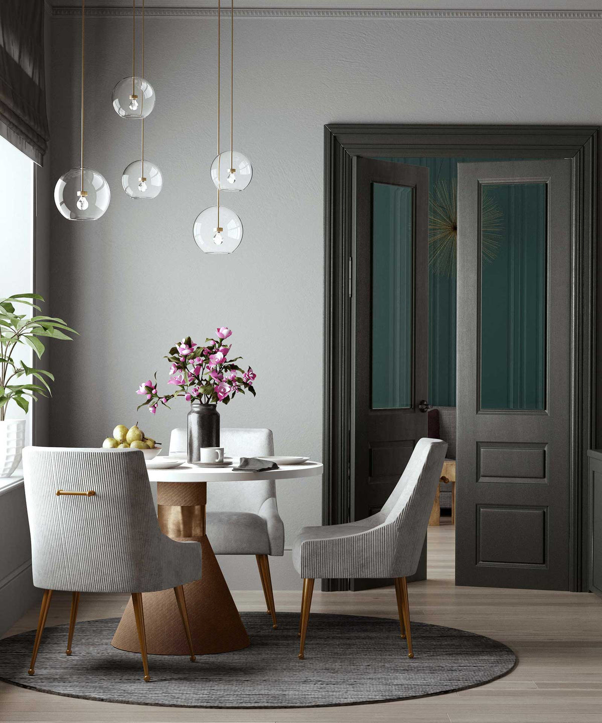 Light gray pleated velvet chairs brighten a round dining table with sculpted backs and gold details.