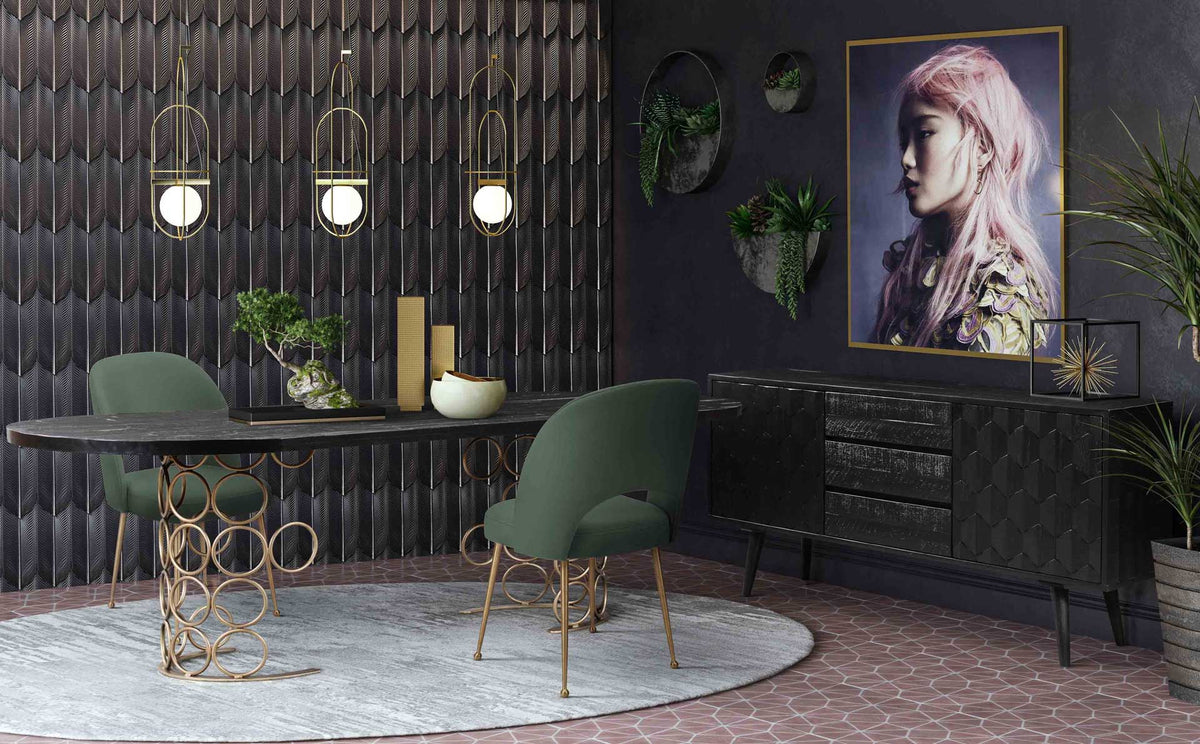 Forest green velvet chairs add depth and golden accents to a richly styled black dining room