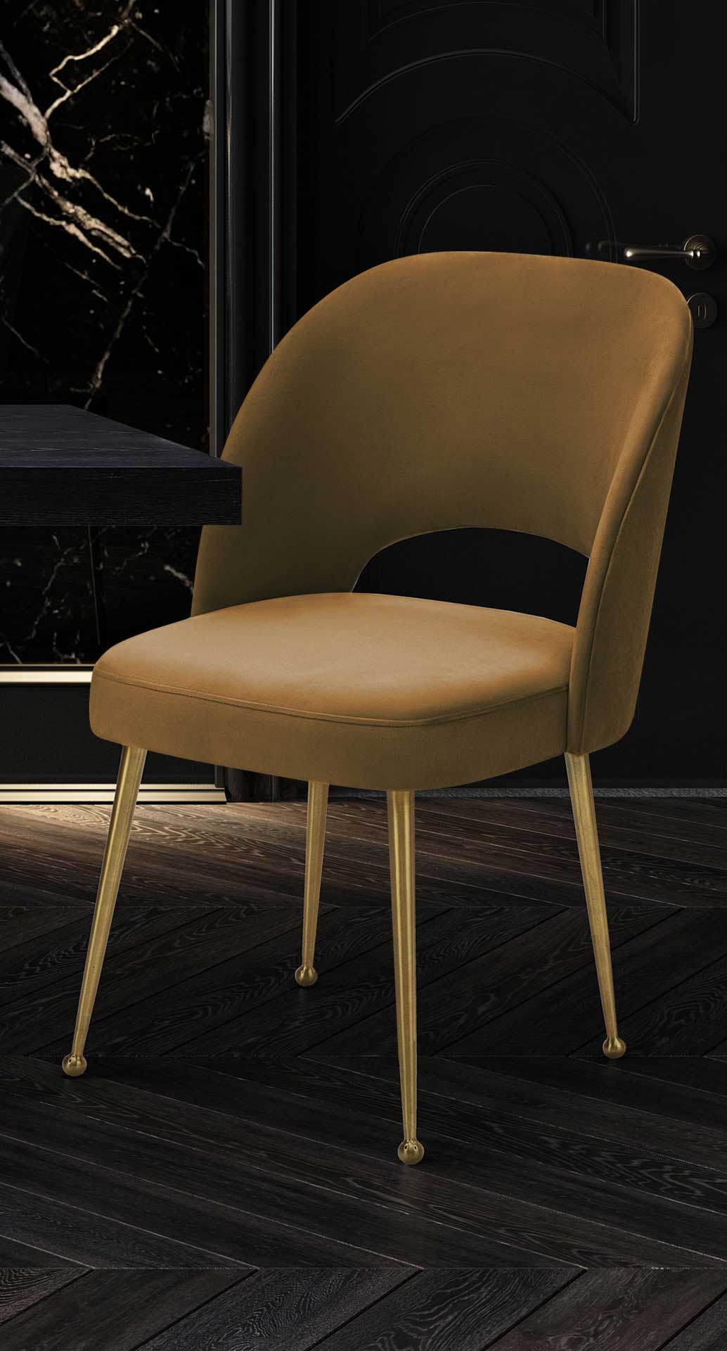 A cognac velvet chair brings warm color and golden accents to a dramatic dark dining nook