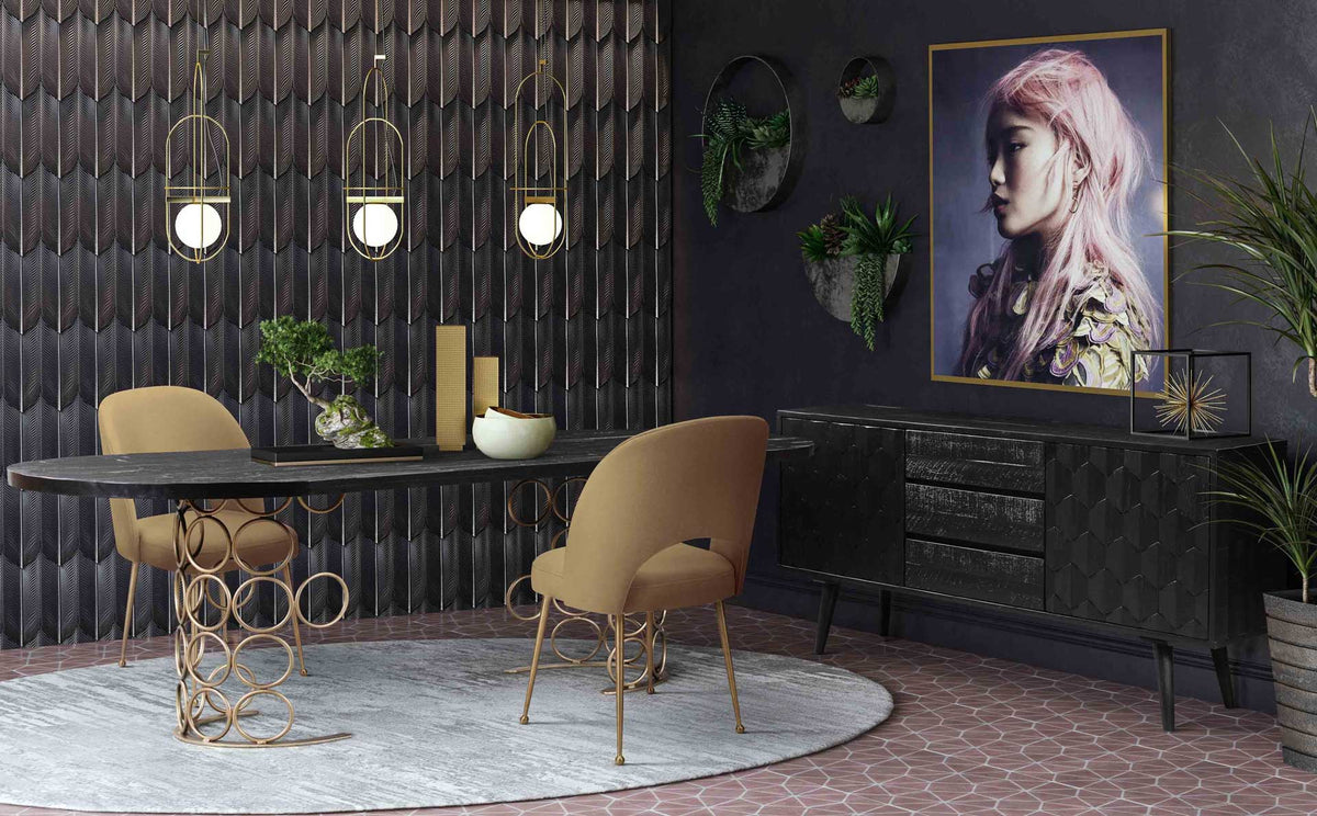 Cognac velvet chairs balance a black dining table with warm upholstery and slim gold legs